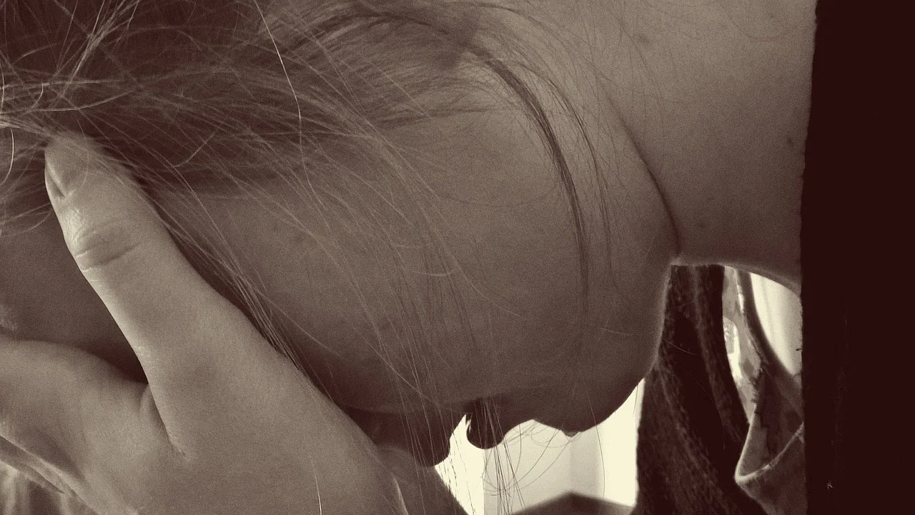 woman crying head in hands.jpg