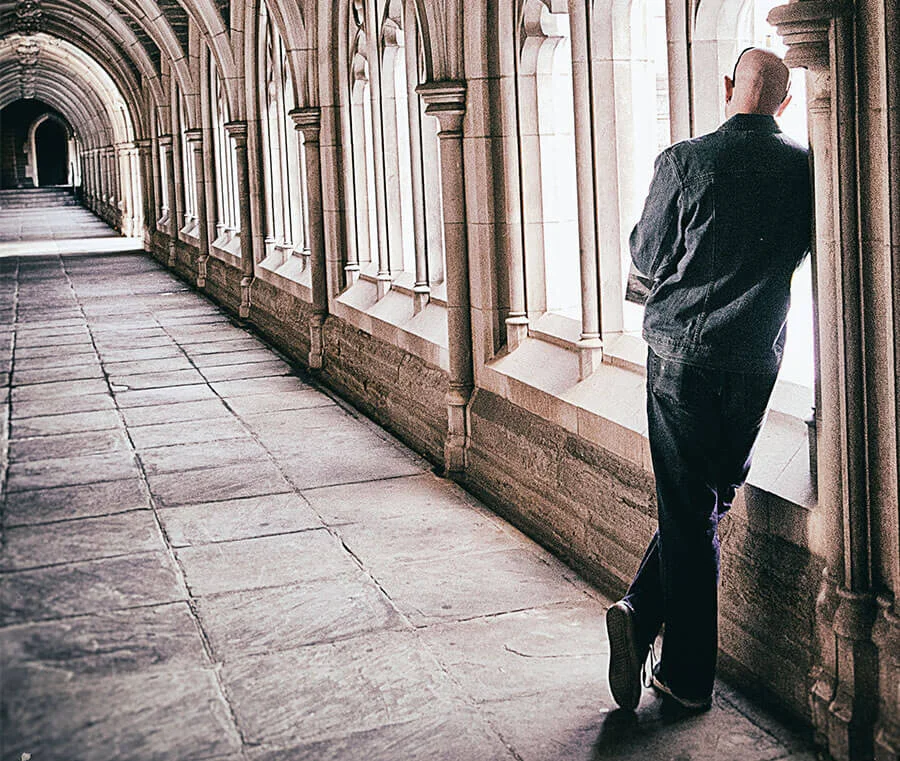 sad man in stone hallway
