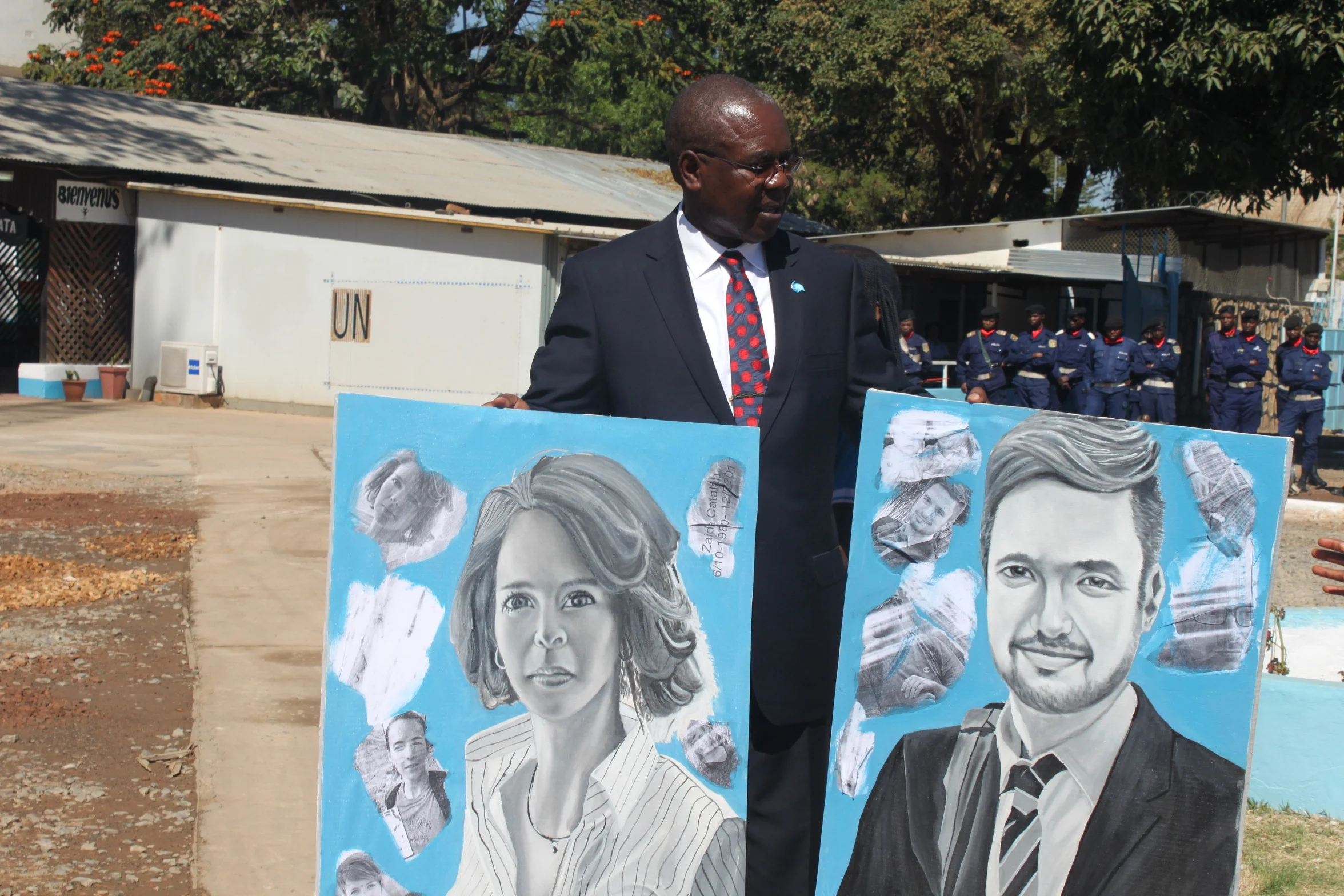 The Chief of MONUSCO Office, Josiah Obat, displays portraits of two murdered UN experts, Zaida Catalan and Michael Sharp. ( Flickr )