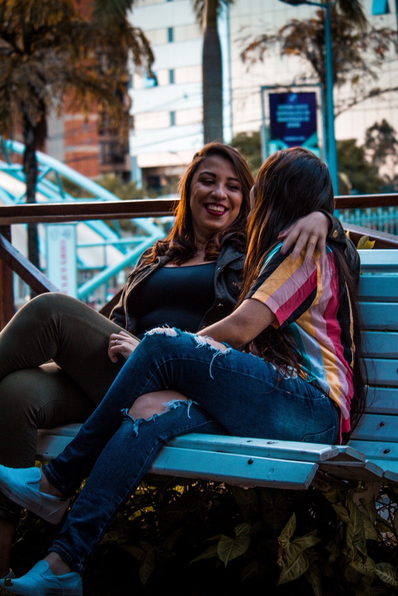 two-women-sitting-on-white-wooden-bench-2546888.jpg