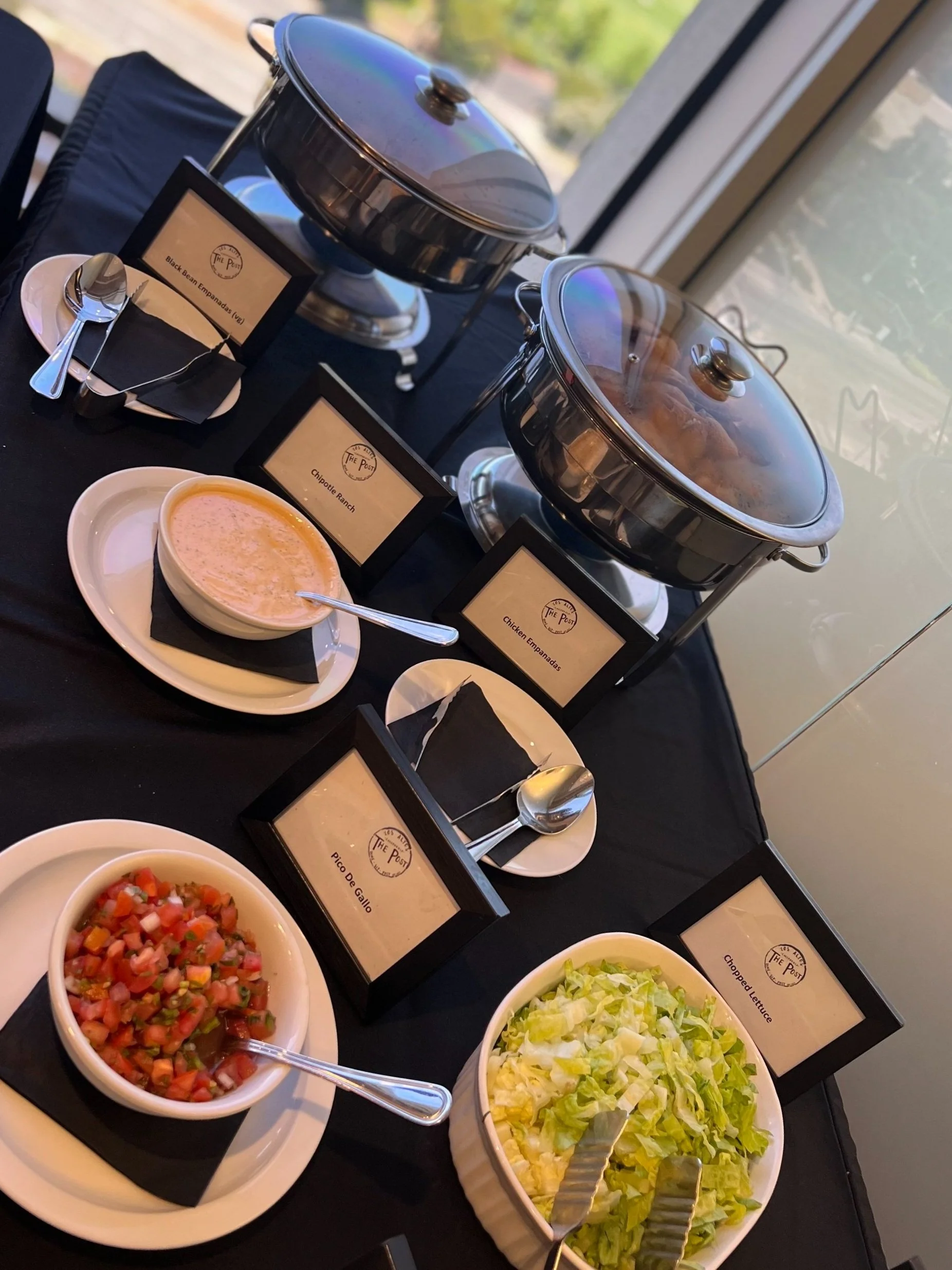 Catering buffet by The Post Los Altos with chafing dishes and salads