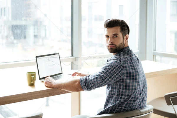 8395705_stock-photo-handsome-man-in-office-coworking-while-using-laptop-computer.jpg
