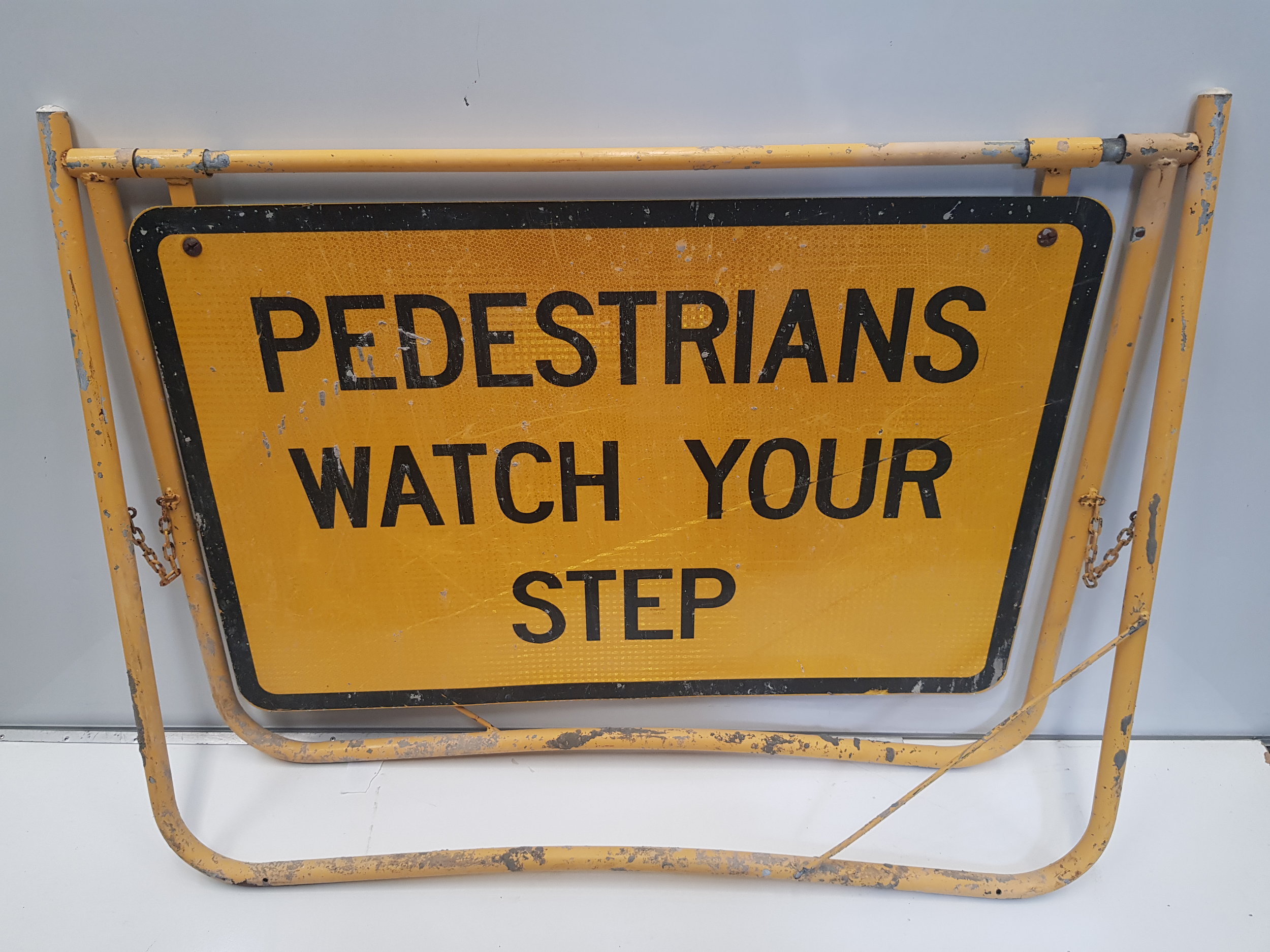Pedestrians Watch Your Step Swing Stand Sign.jpg