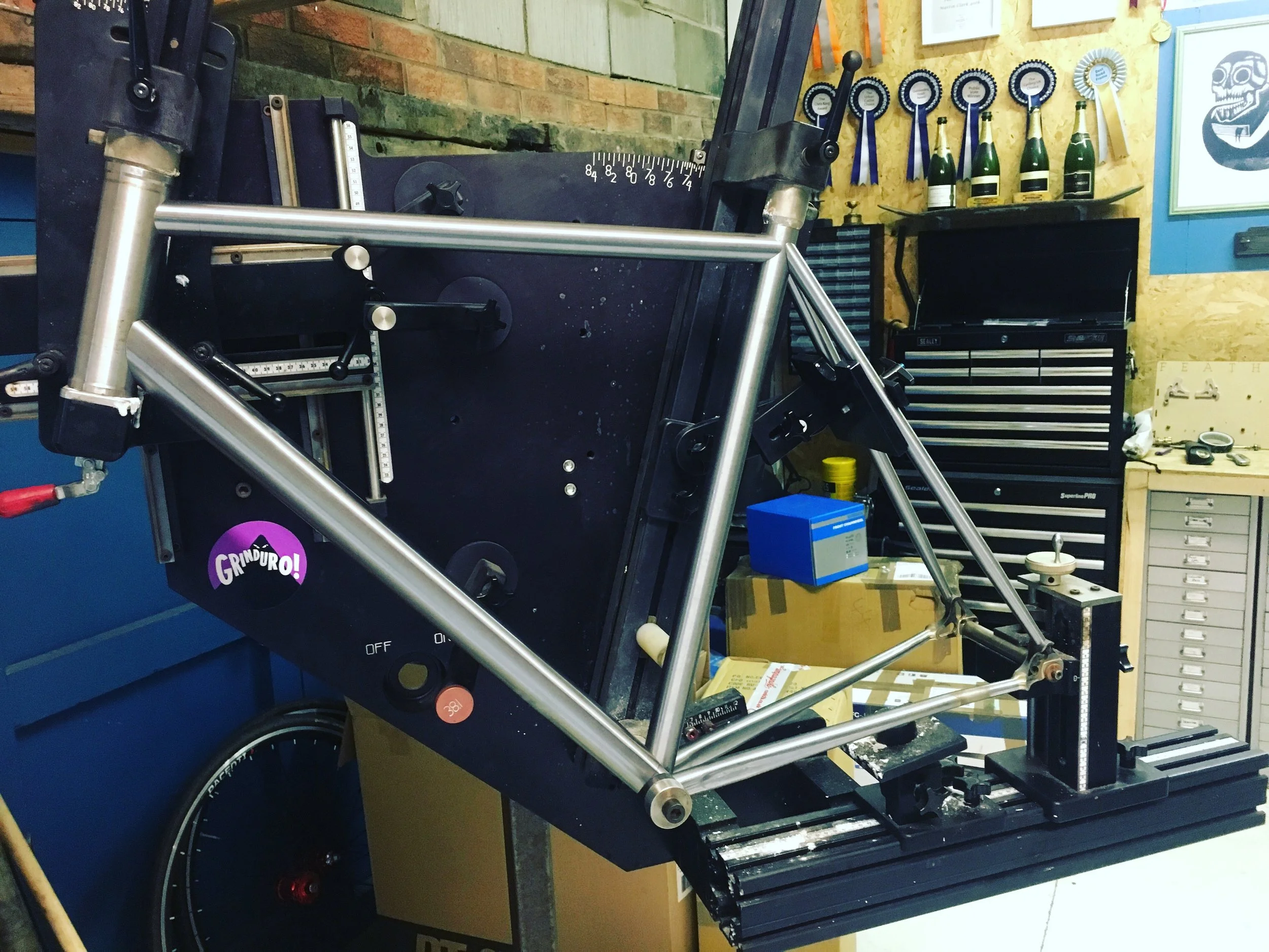 Mitred modern road bike frame in the frame fixture.