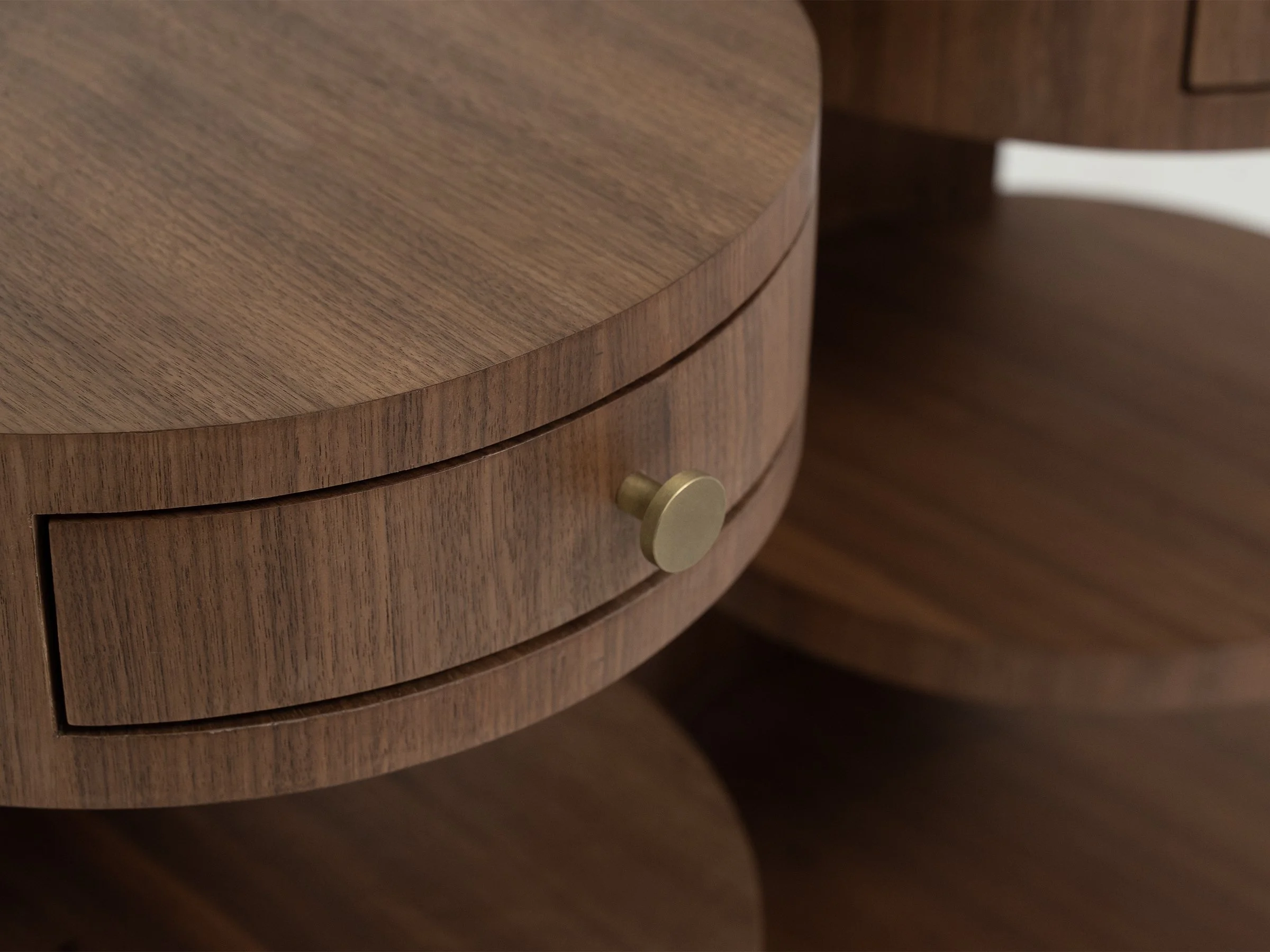 Aram Stand shown in natural walnut with antique bronze knob, teardrop-shaped with a single drawer and two round shelves. Detail.