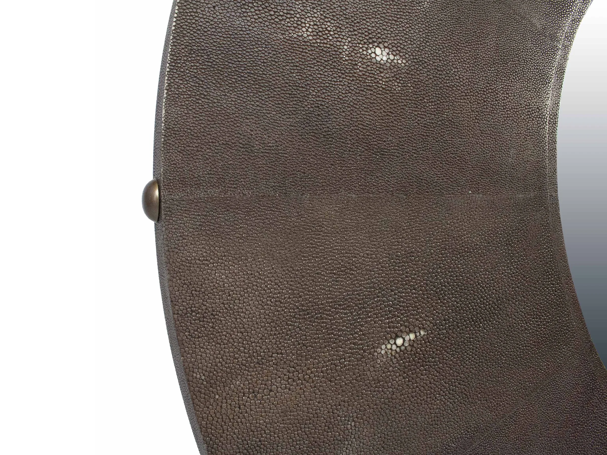 Close-up of shagreen texture and decorative pin on Bull’s Eye Mirror in truffle finish.