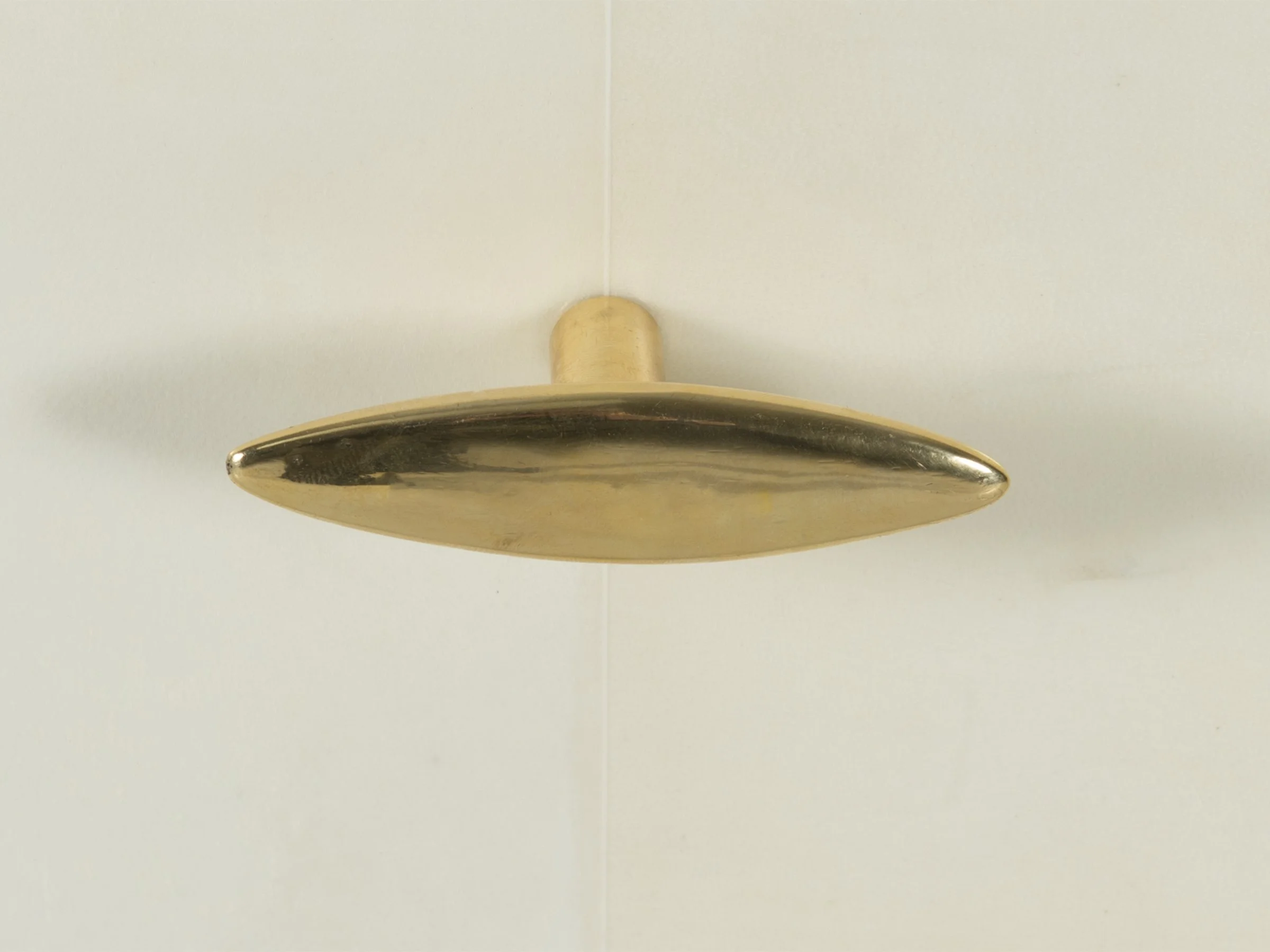 Glenn Dresser in Bleached Parchment with bronze hardware, close up view