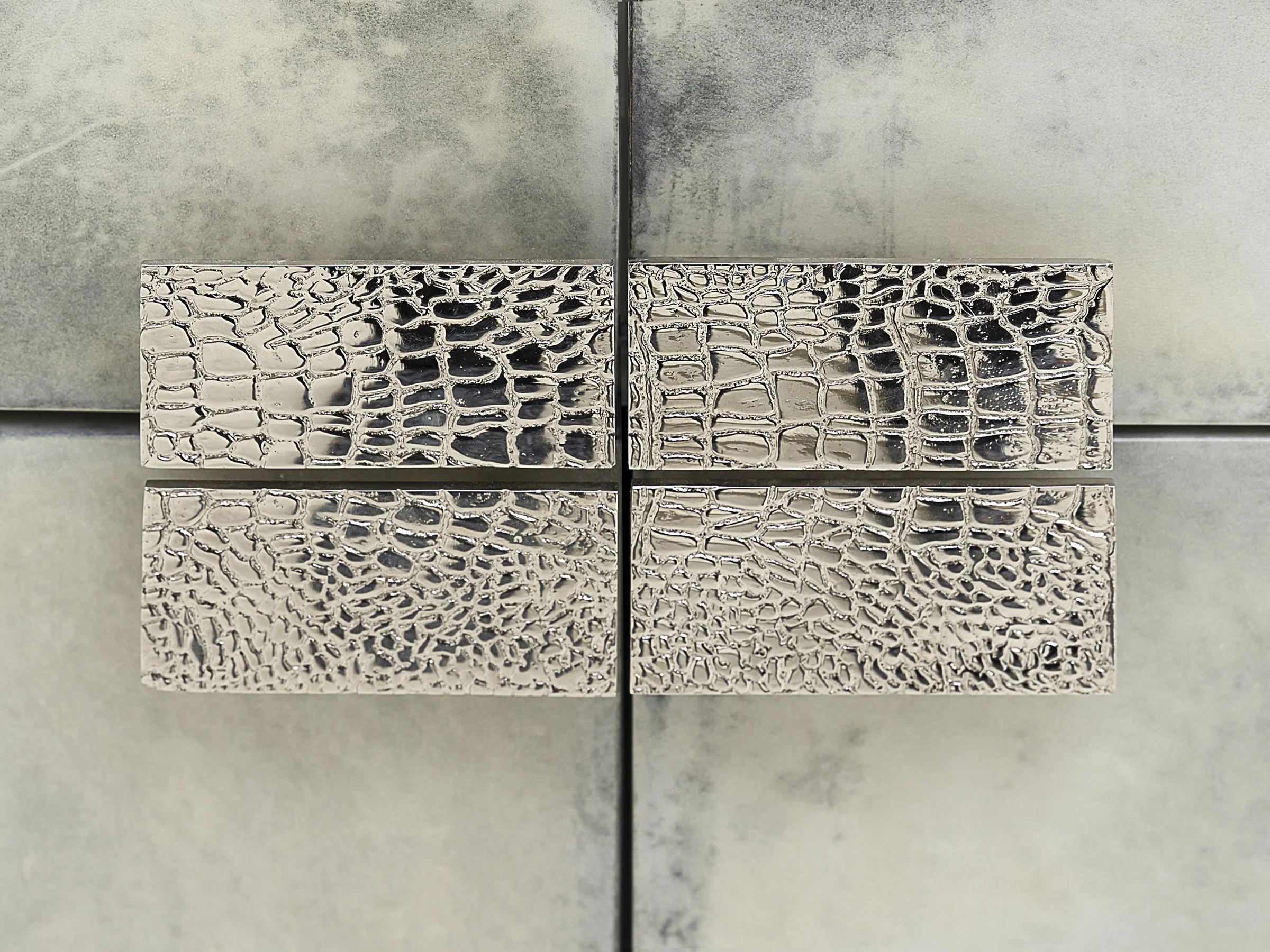 Detail view of polished white bronze "alligator" pulls.