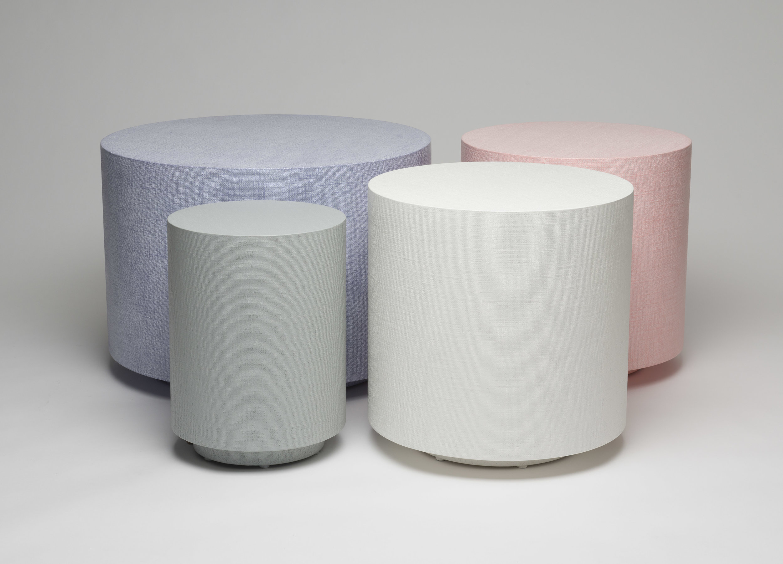 A grouping of Cylinder Side Tables in Various Lacquered Linen finishes.