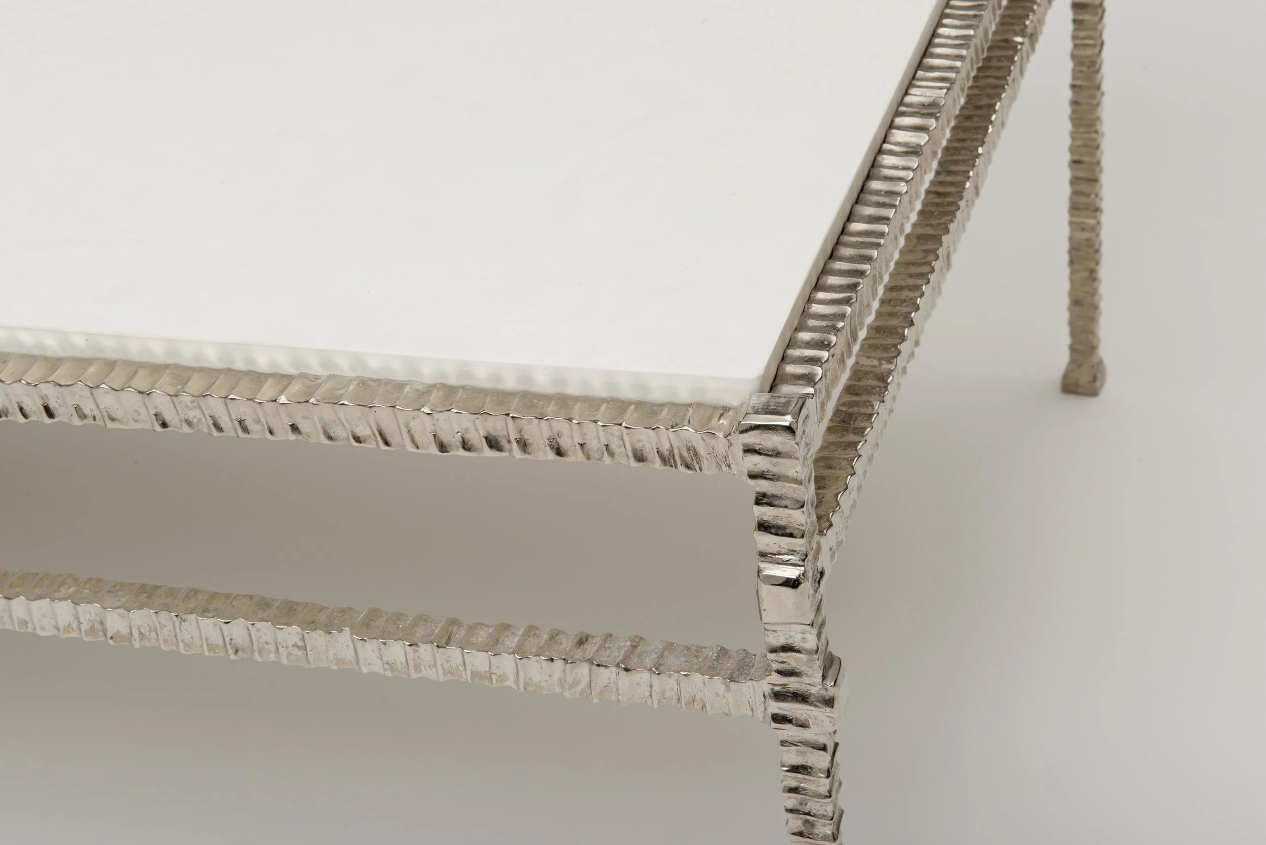 Front view of The Forged Bronze Table IV in Polished White Bronze with Limestone Top