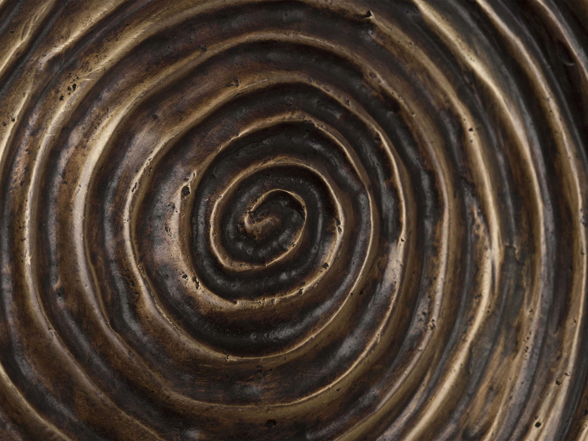 Detail view of Babylon Bowl in oil-rubbed bronze with carved spiral ridges.