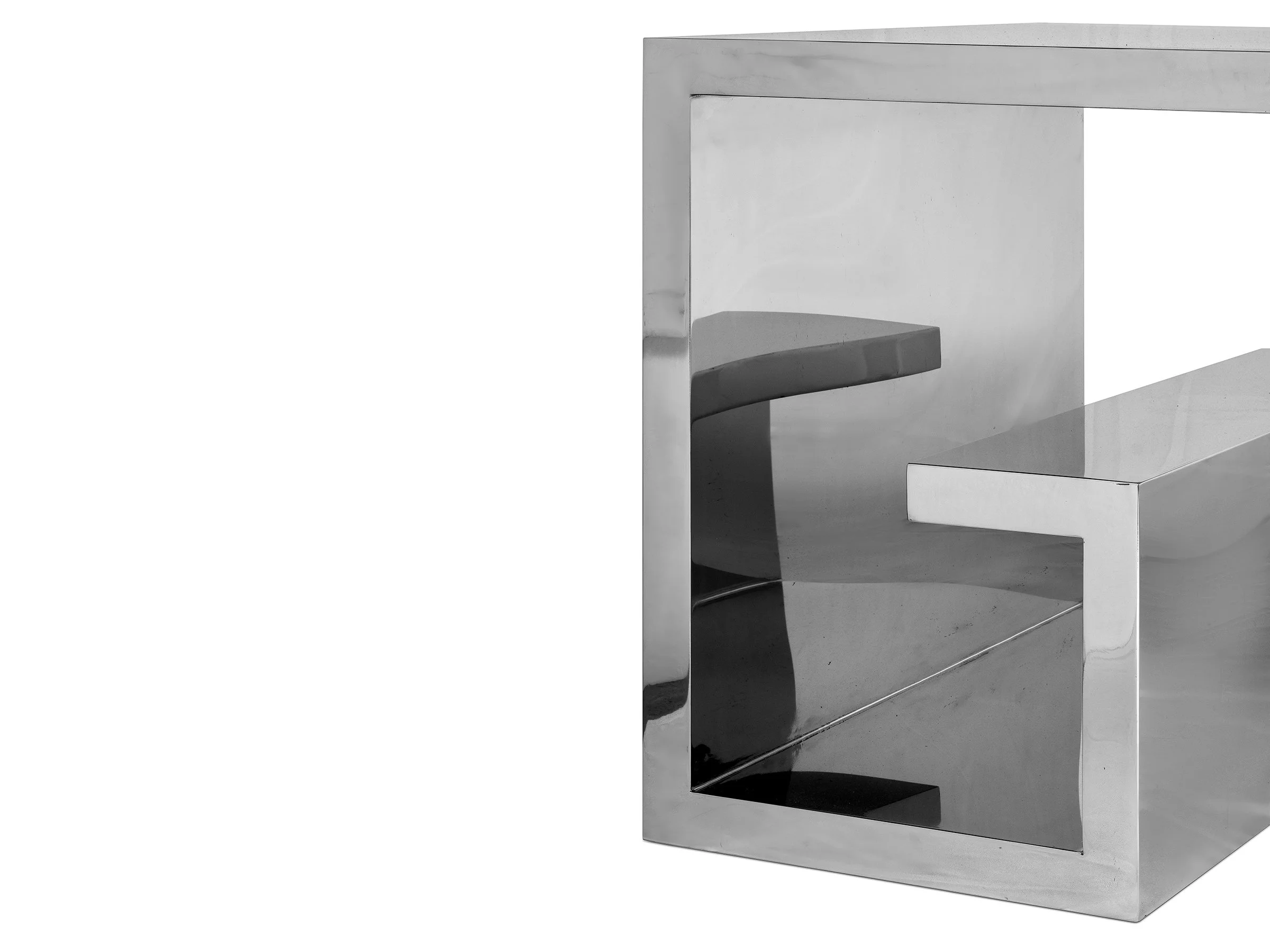 Close-up of the Euclid Desk base detailing the integrated shelf and polished steel construction