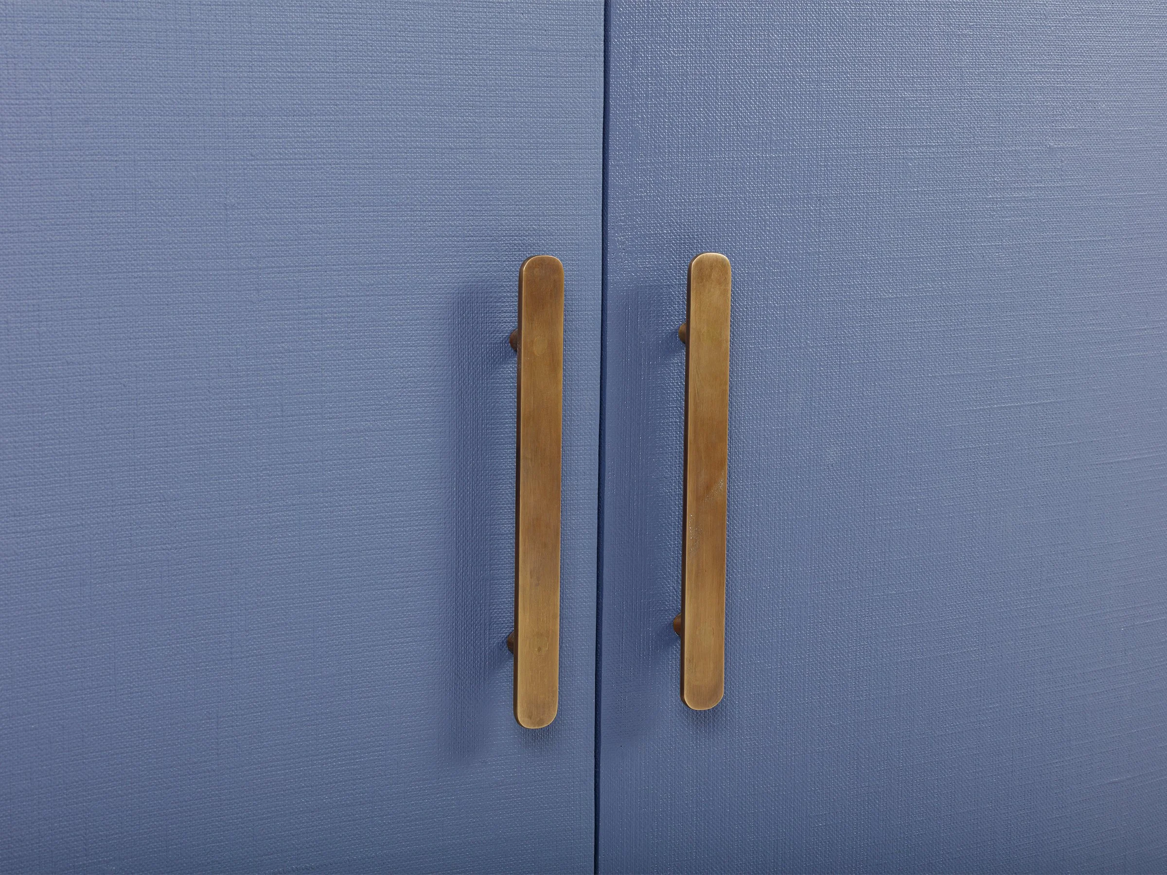 Detail view of the New Wave Cabinet in New Navy lacquered linen showing antique bronze handles..