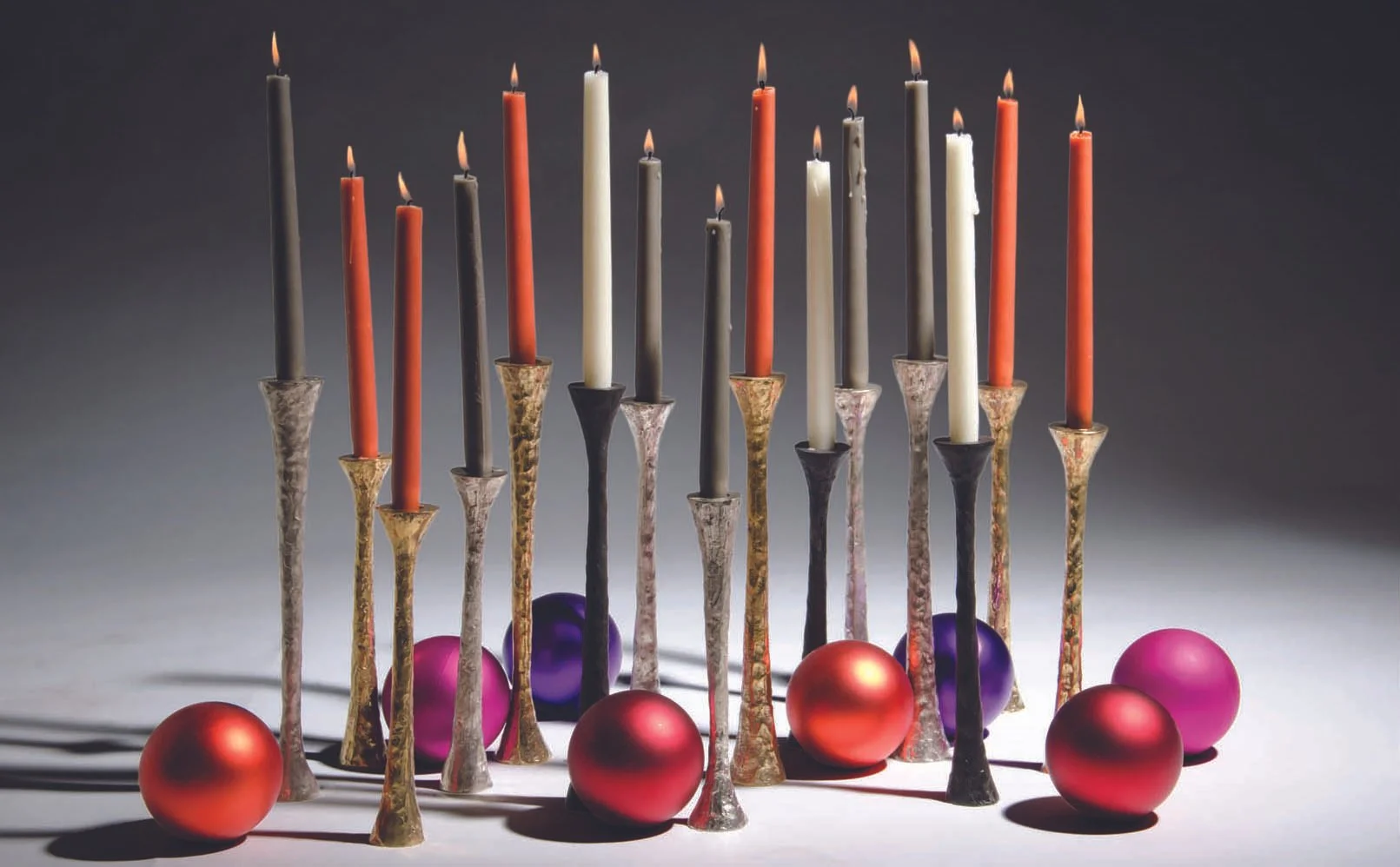 Thebes Candle Holders set with colorful taper candles and holiday ornaments