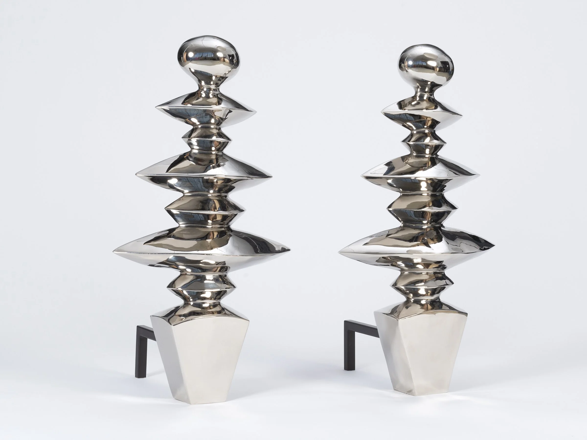 Zig Zag Colossus andirons in polished white bronze, angle view.