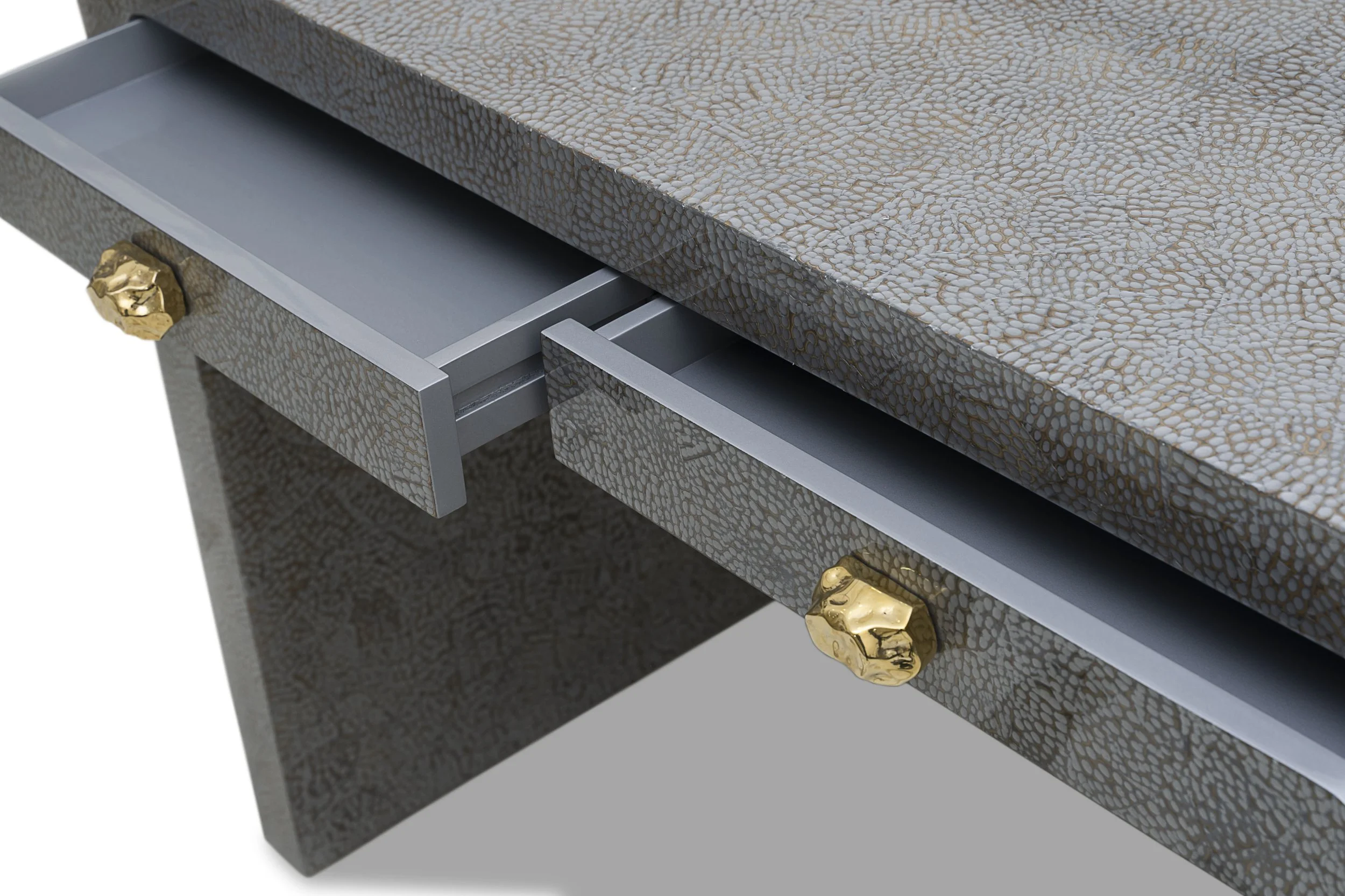 Close-up of drawer detail with brass pull and texture of silver snakeskin eggshell lacquer