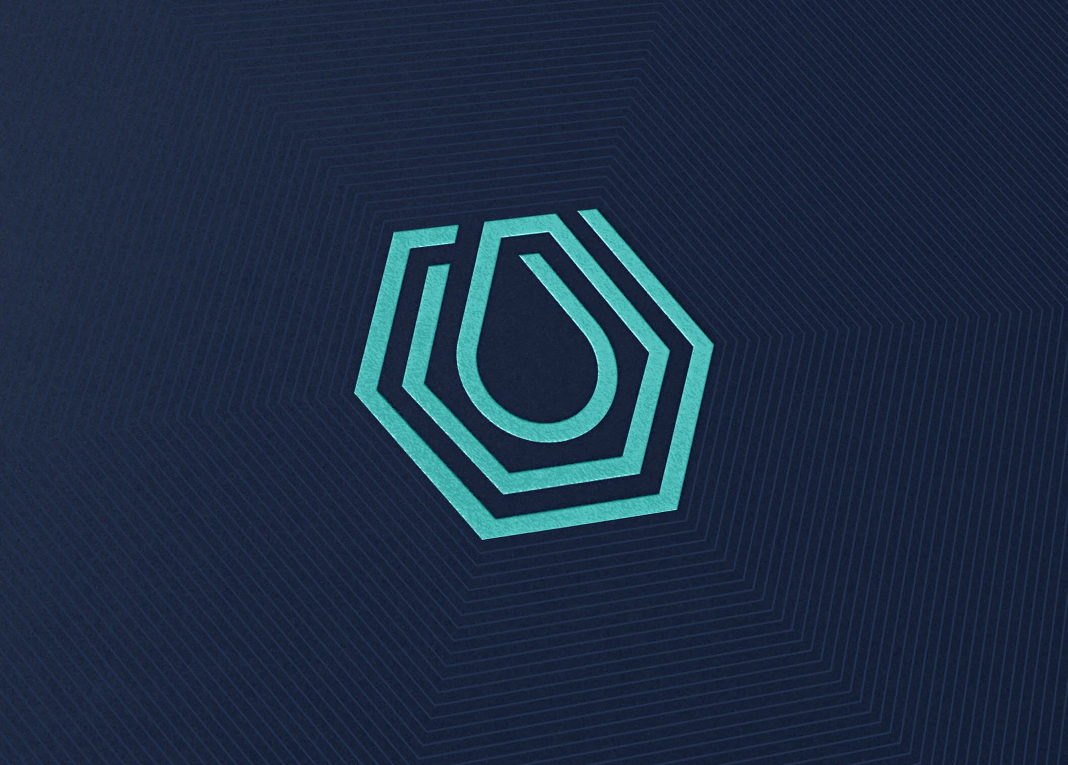 A digital logo with a geometric, shield-like design in shades of blue on a dark, textured background.