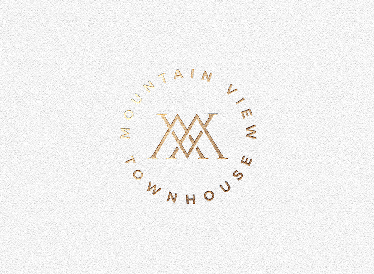 Gold logo with stylized letters 'X' and 'A' in the center, surrounded by the text 'Mountain View' and 'Townhouse' on a textured white background.