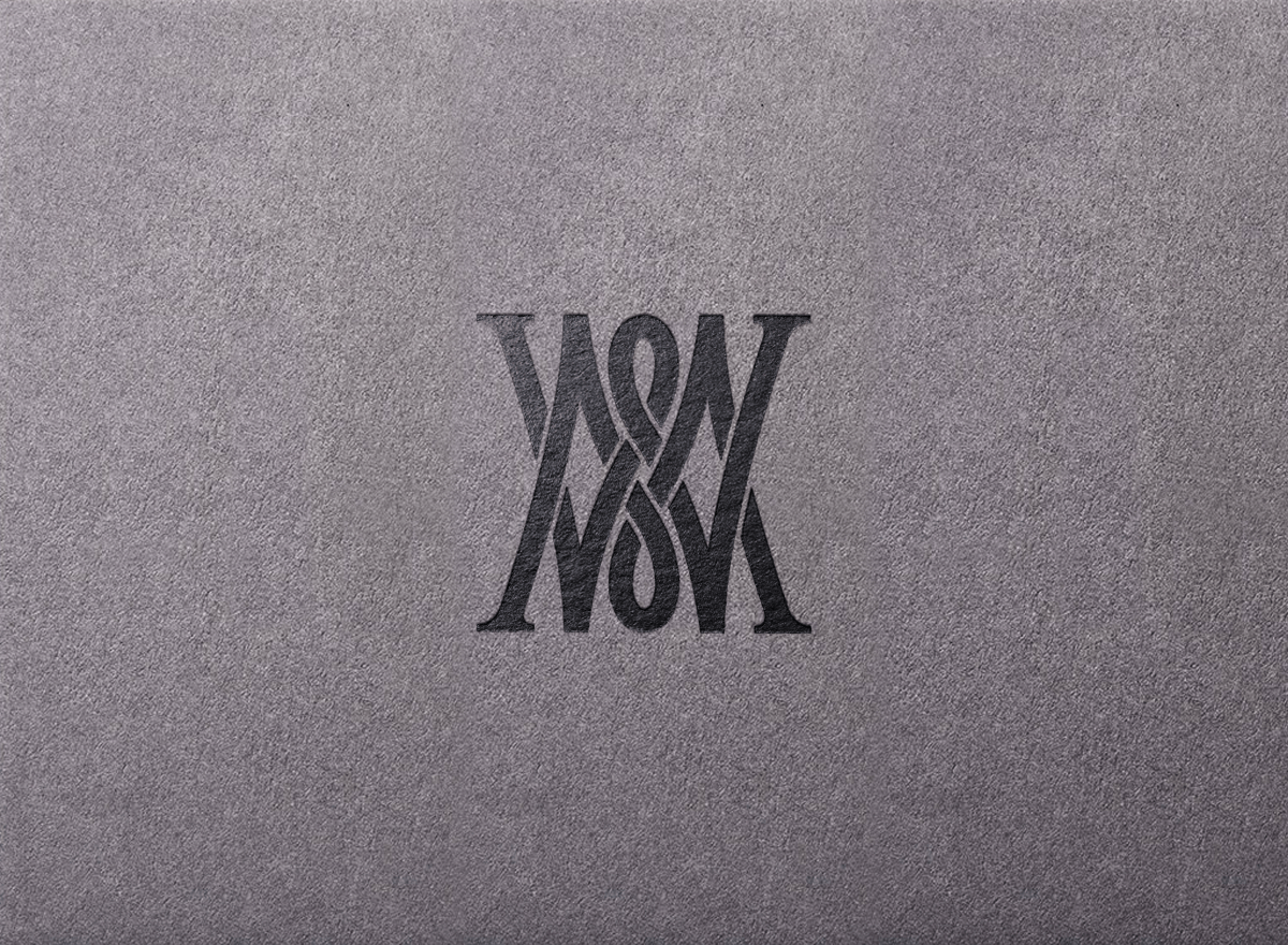 A gray surface with a black, stylized, mirrored 'WONXY' logo in the center.