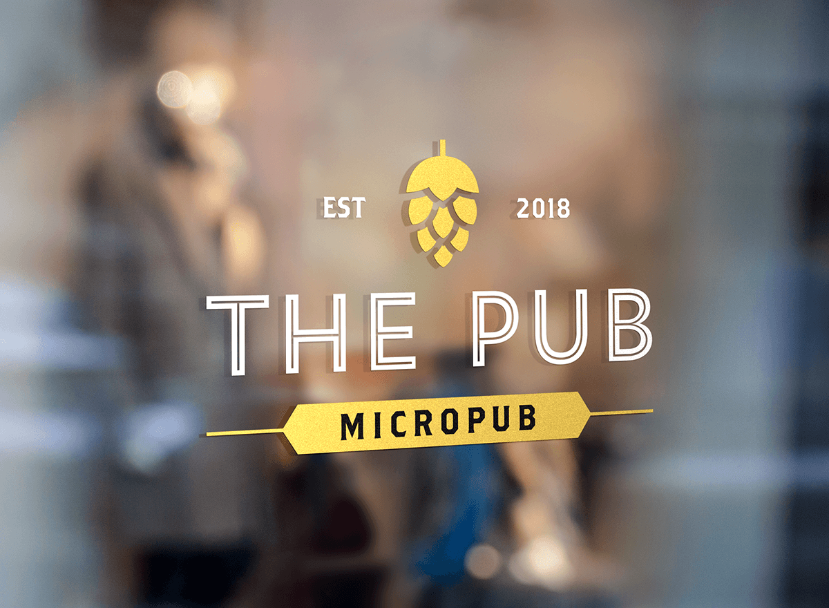 A blurred image of a pub window with the logo and text "The Pub Micropub," established in 2018, with a hop cone symbol at the top.