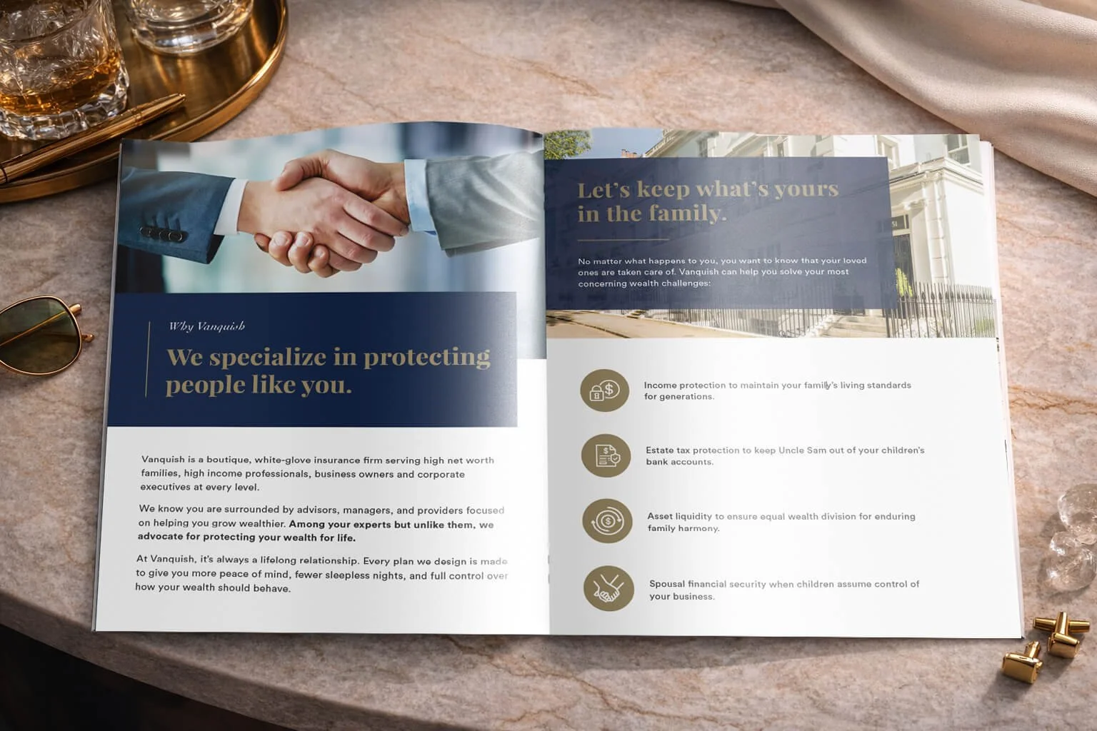 Open brochure on a marble surface with a handshake image on the left page and family protection messaging on the right page, gold and black icons, sunglasses, gold clips, and a drink tray nearby.