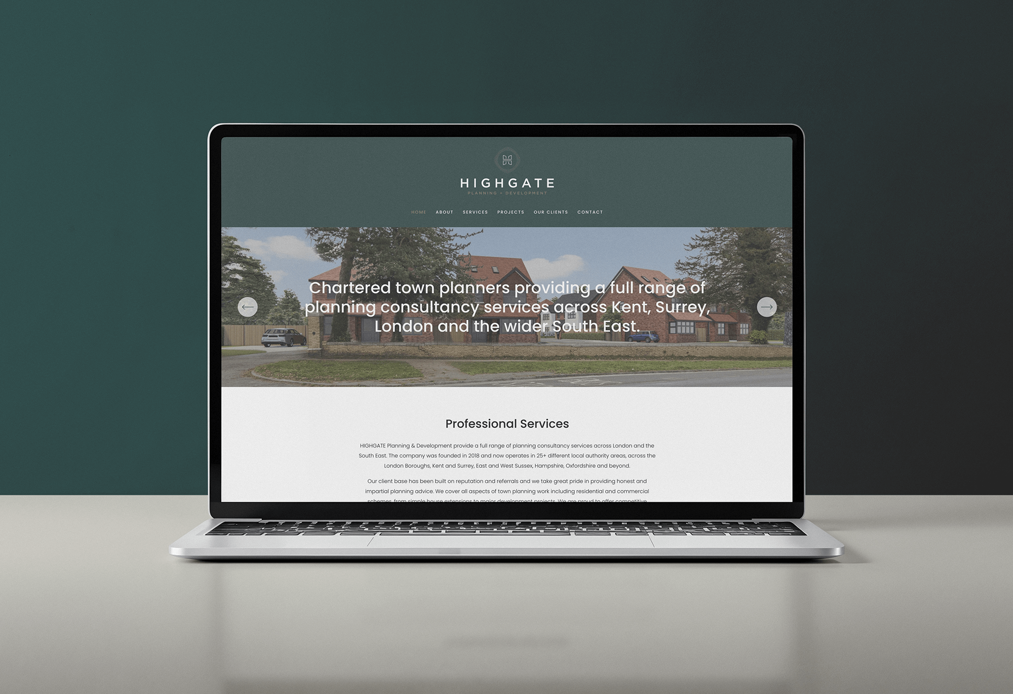 Laptop displaying a website for Highgate Planning and Development with a header image of houses and trees.