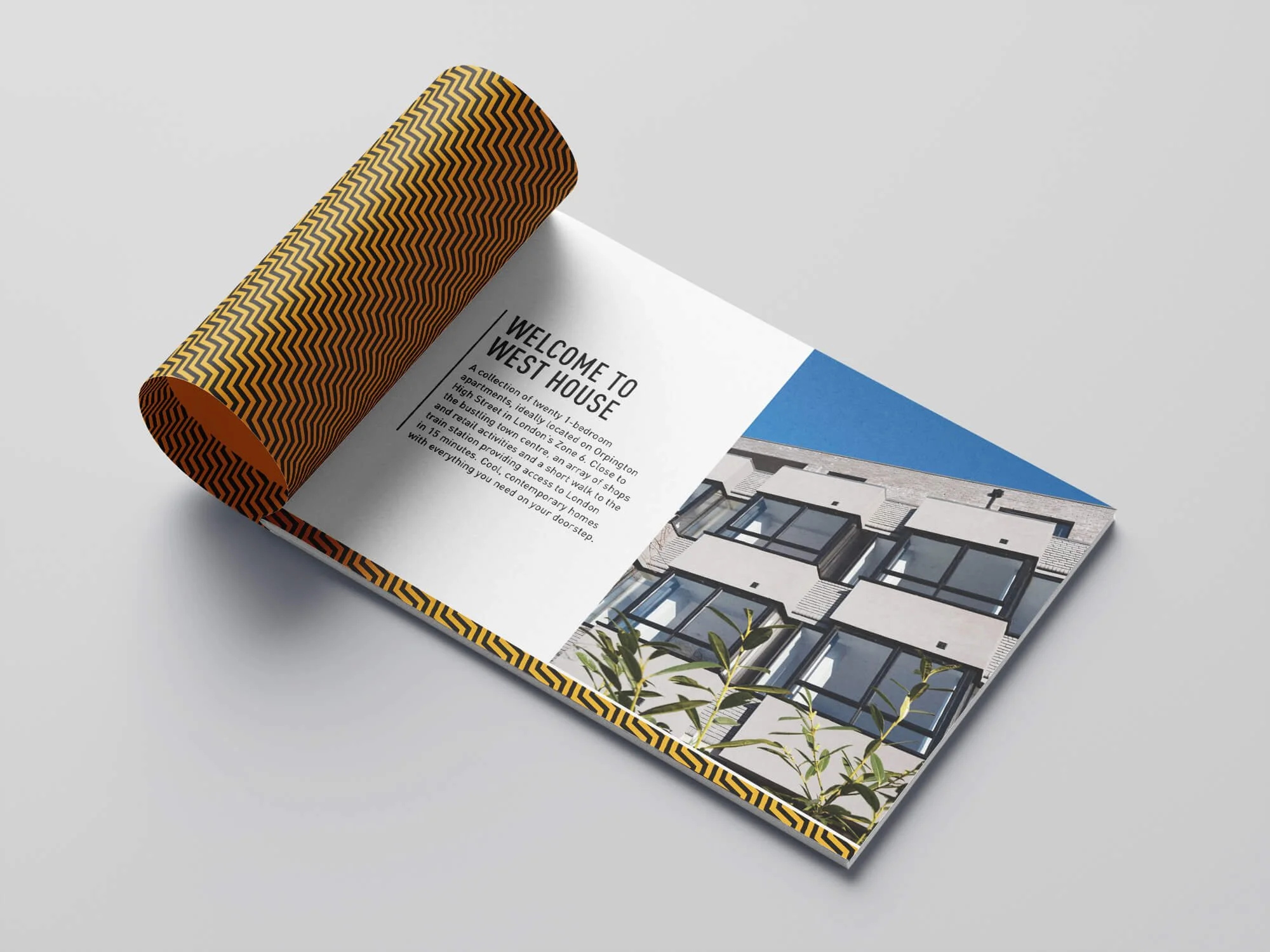 Open brochure for West House with a patterned yellow and black cover, showing an interior description page and a modern building exterior with large windows on a blue sky background.