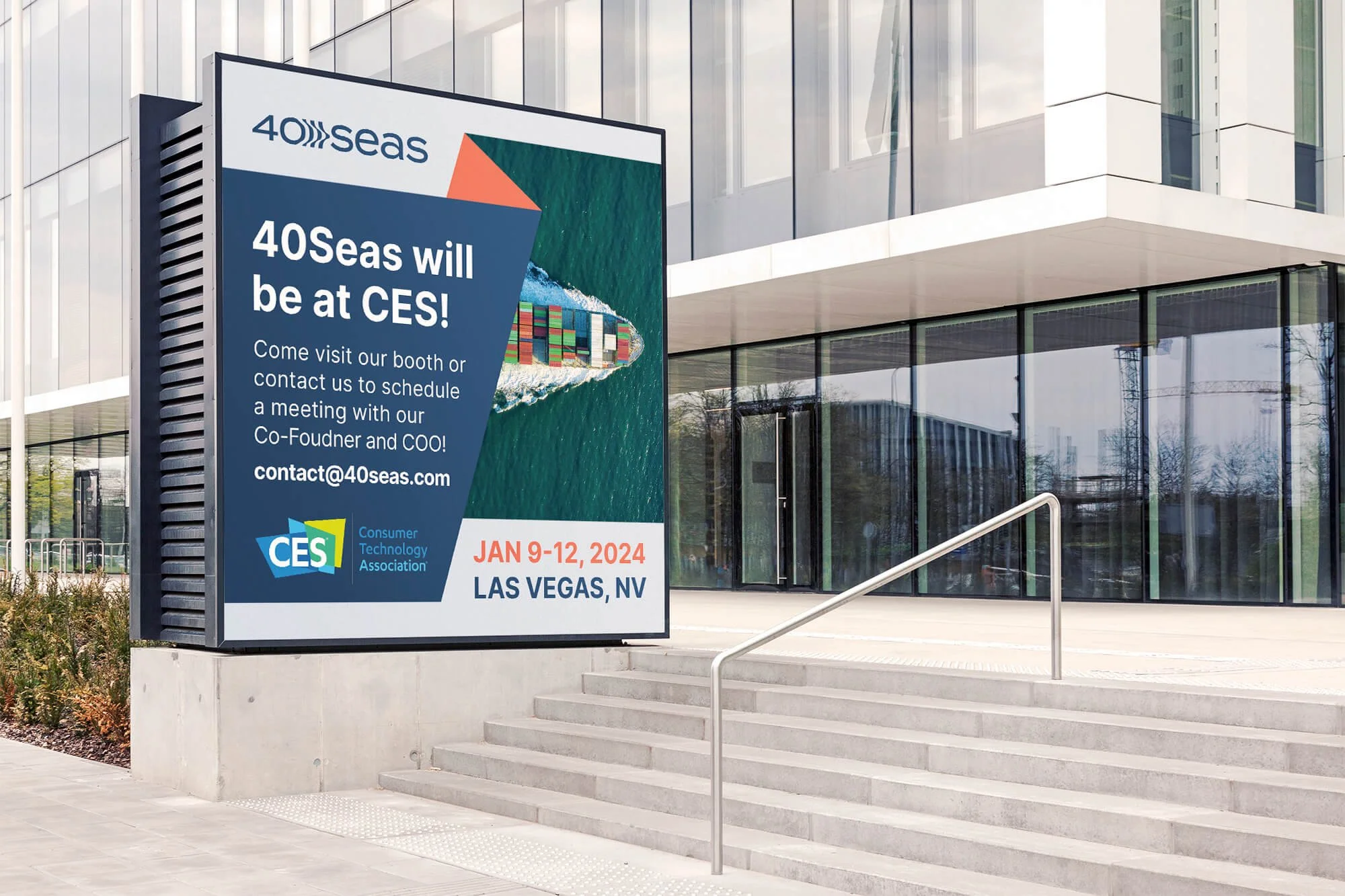 Large digital billboard announcing 40Seas will be at CES, located outside a modern building with glass windows in Las Vegas, Nevada. The billboard includes event dates January 9-12, 2024, and an aerial image of a container ship at sea.