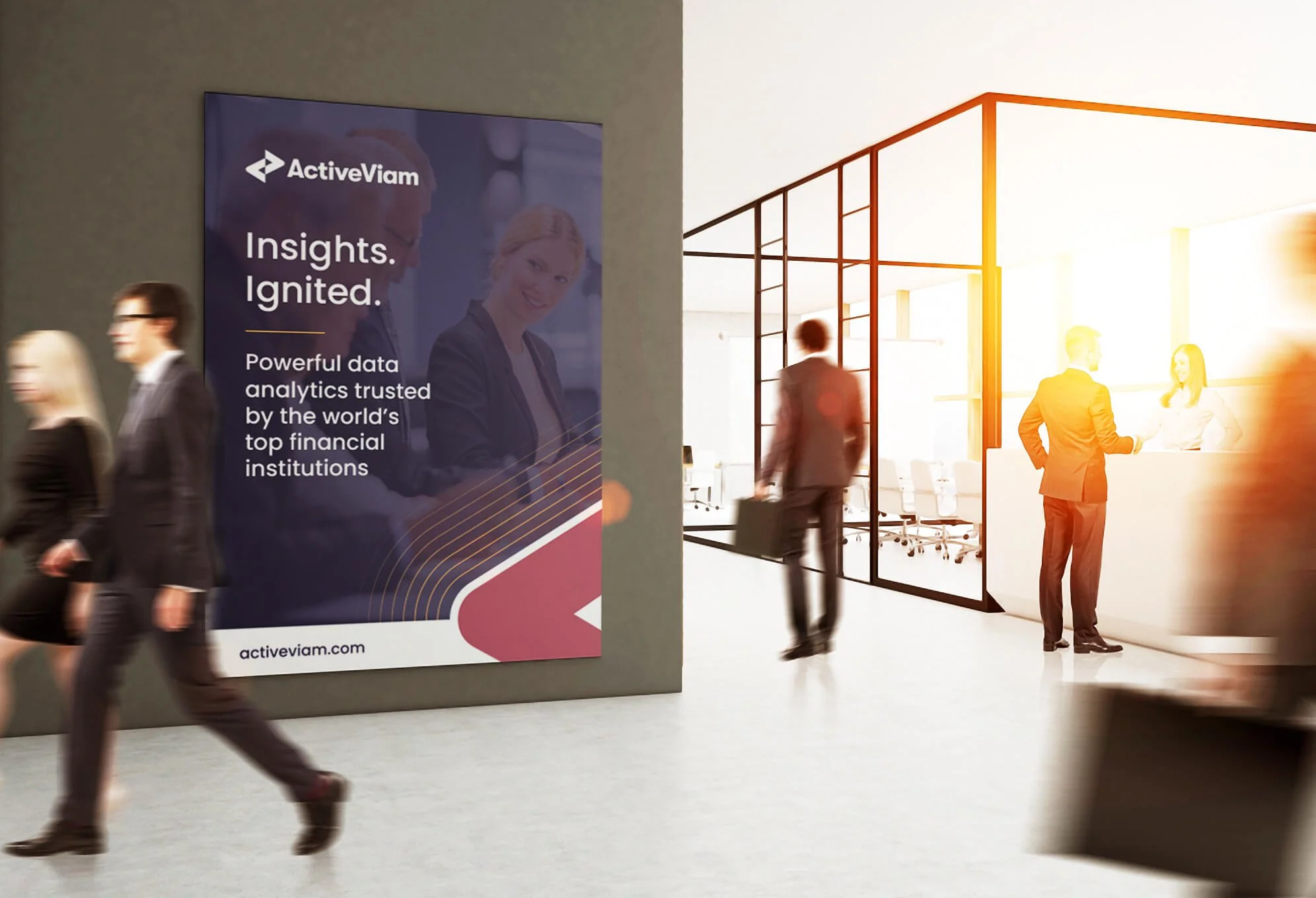 Businesspeople walking past a large poster for ActiveViam with the slogan 'Insights. Ignited' and text about data analytics trusted by top financial institutions. The scene is a modern office or conference area with glass walls and sunlight.