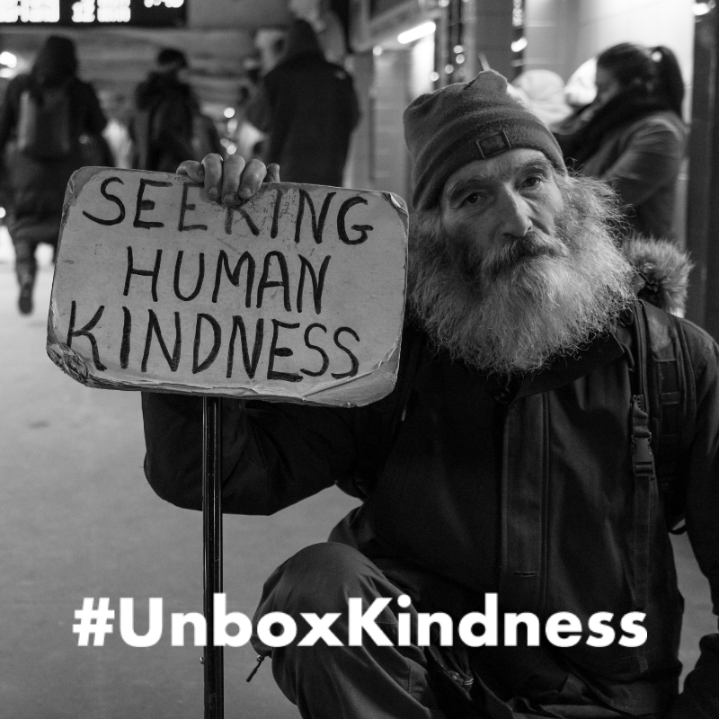 UnboxKindness - Cardboard Sign Background.png