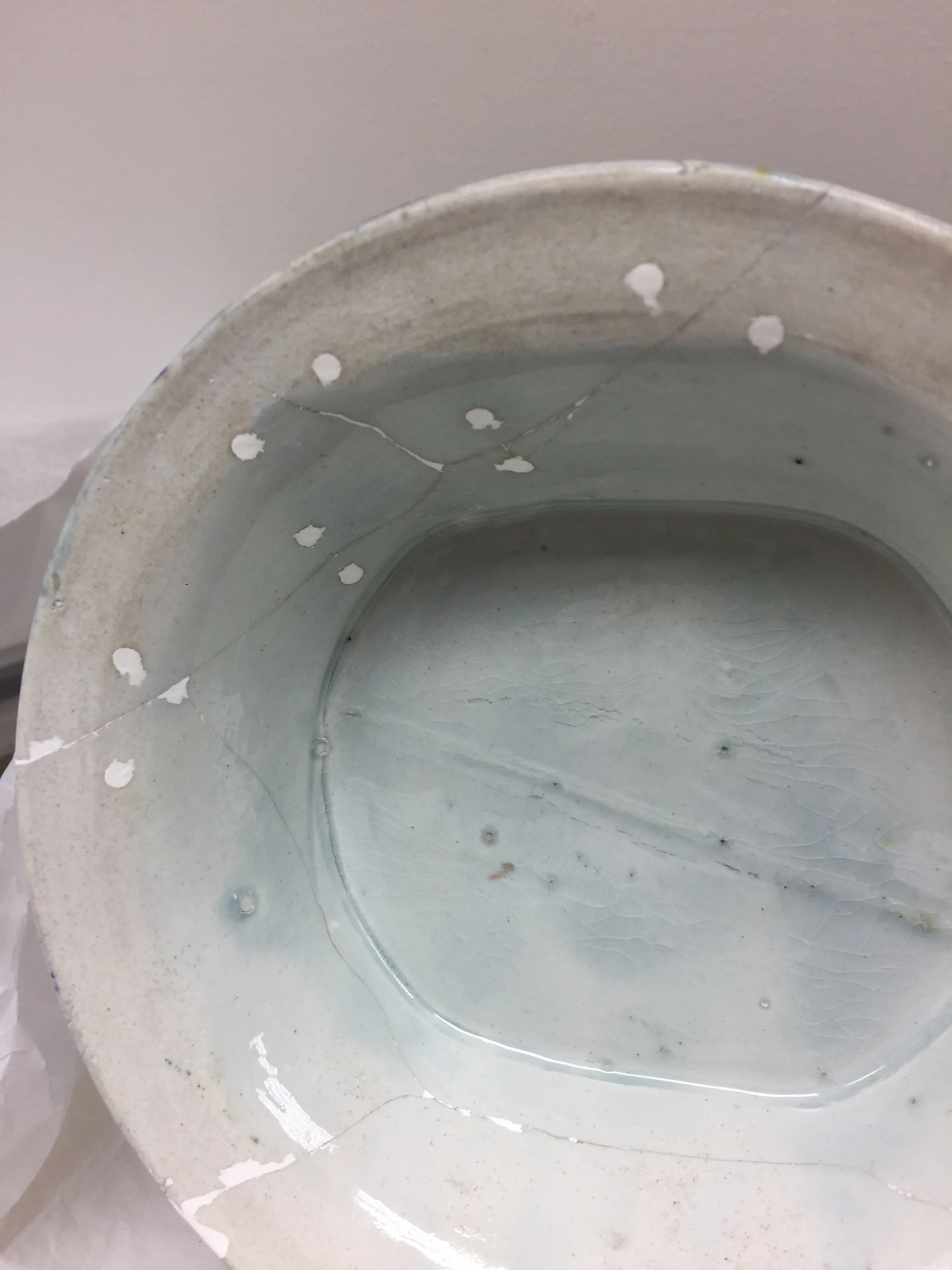  The object was cleaned and the rivets were removed. The loose sections of base were then bonded and areas of loss (including the rivet holes) were filled.  