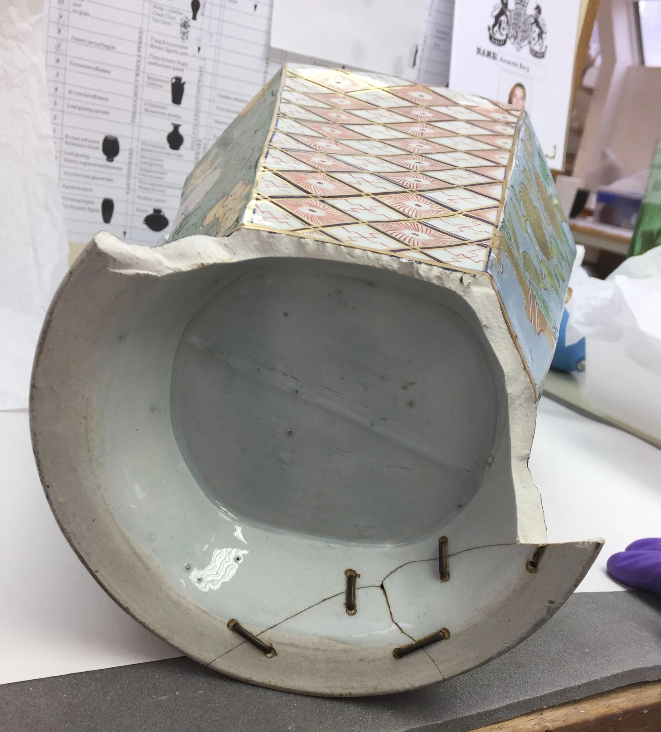  This object had been previously repaired with metal rivets to bind the detached sections of the base together.  