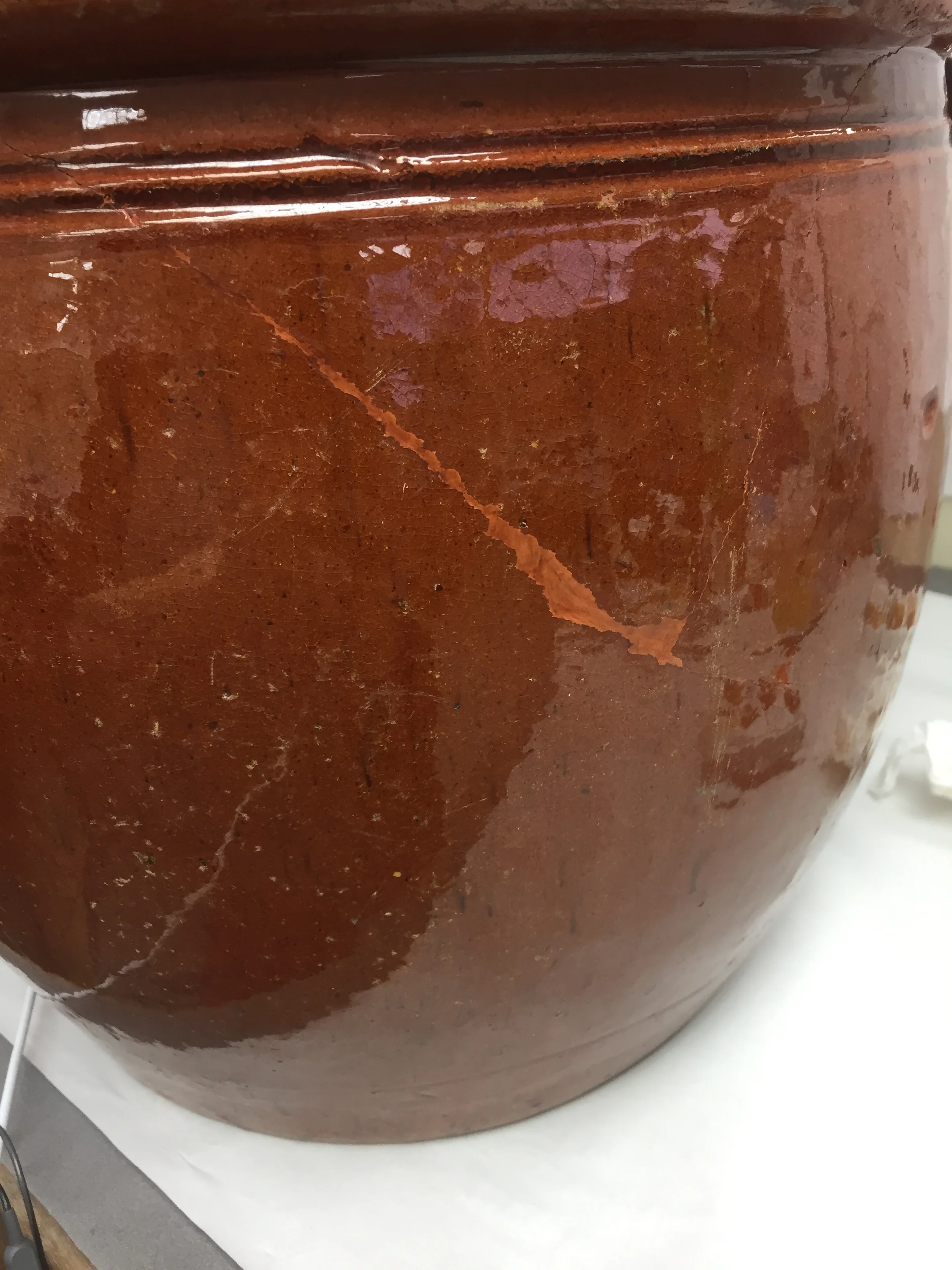  Areas of loss in the body of the pot were also repaired.  