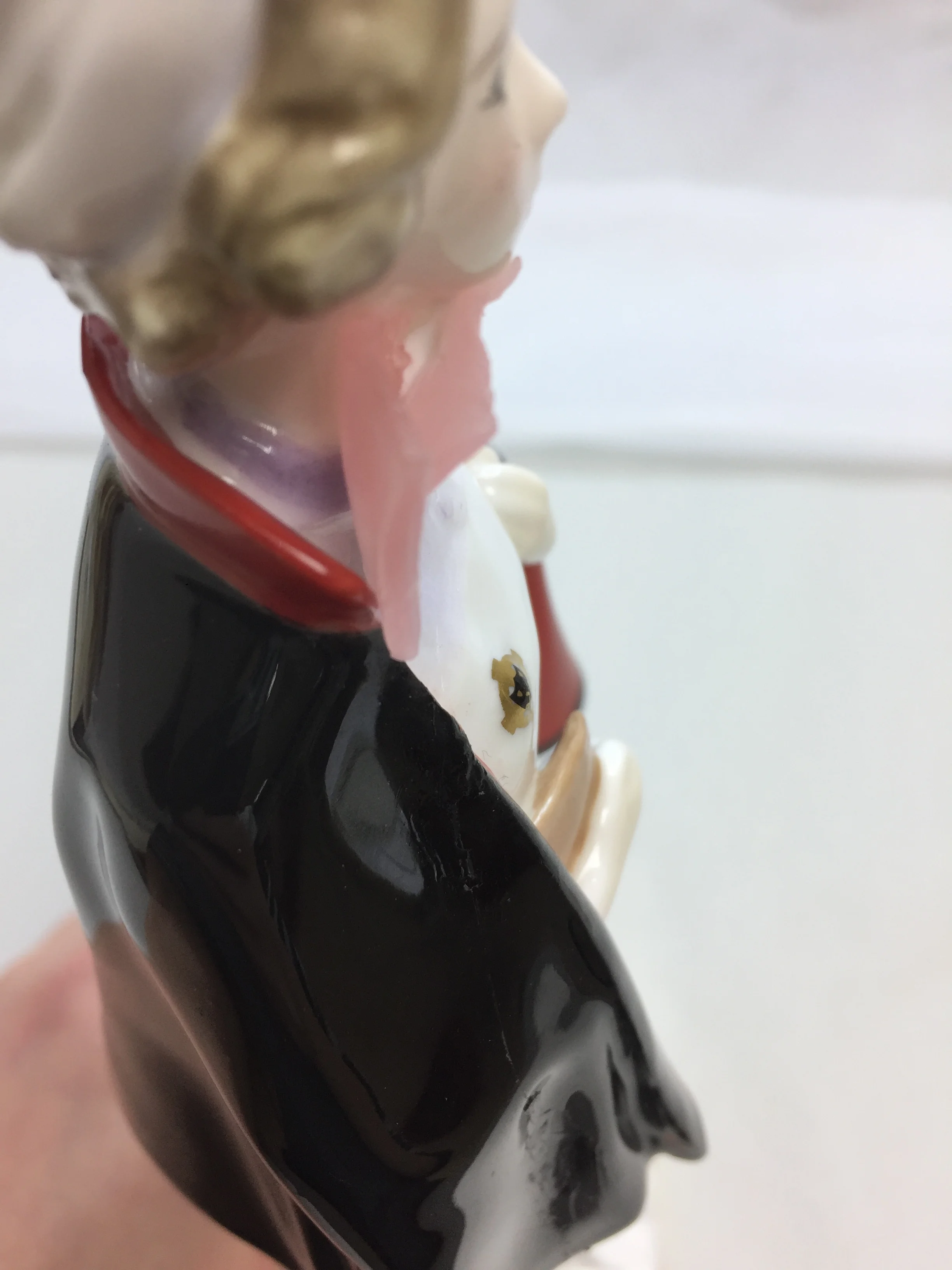  A small area of loss (half of a bow-tie) was repaired by casting tinted epoxy into a wax mold.  