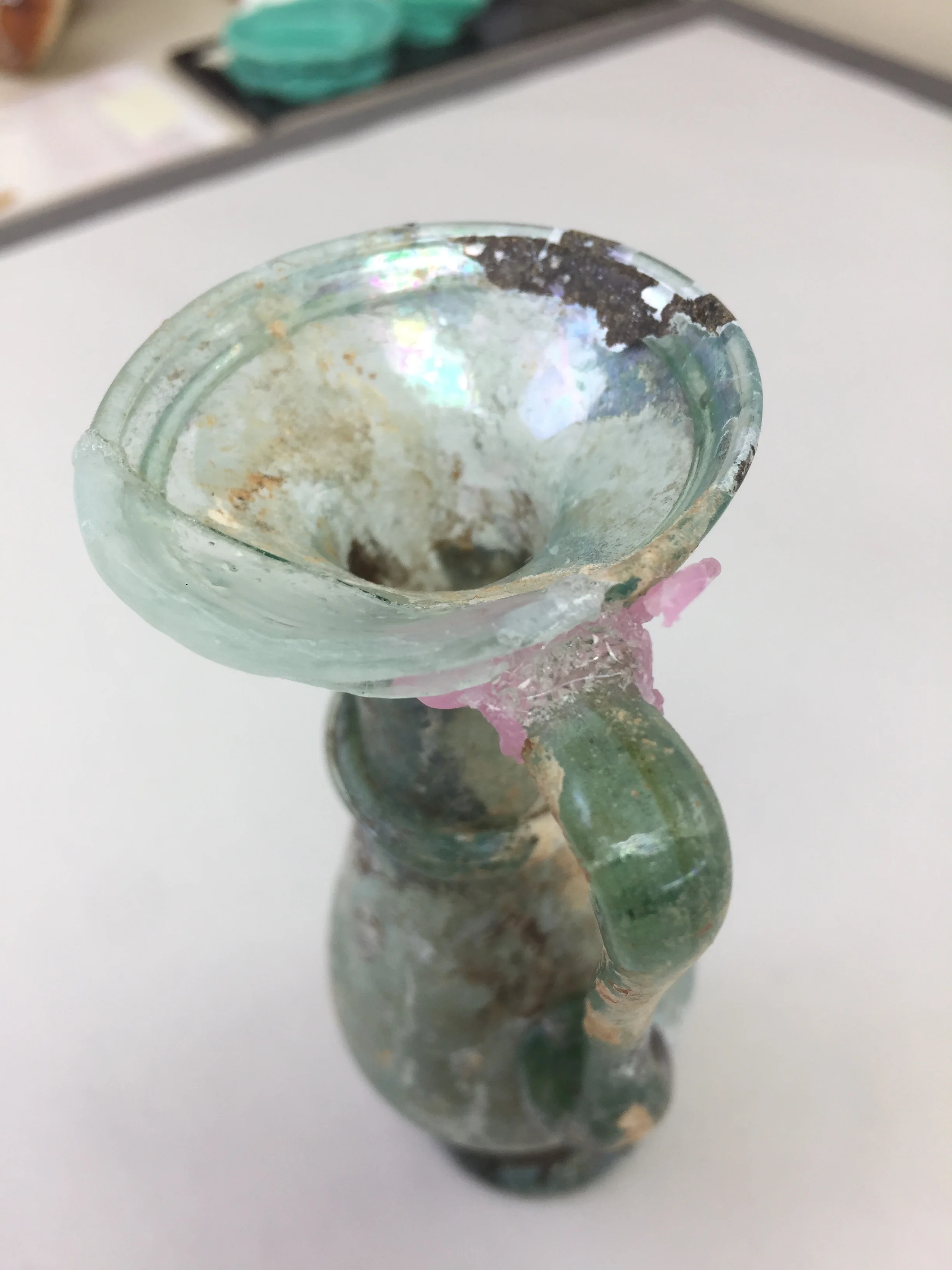  A fill for the rim was modeled, molded and cast in a tinted epoxy. This was carried out without handling the object. The large rim fill was then attached to the object and a “bridge” between the handle and new rim piece was cast.  