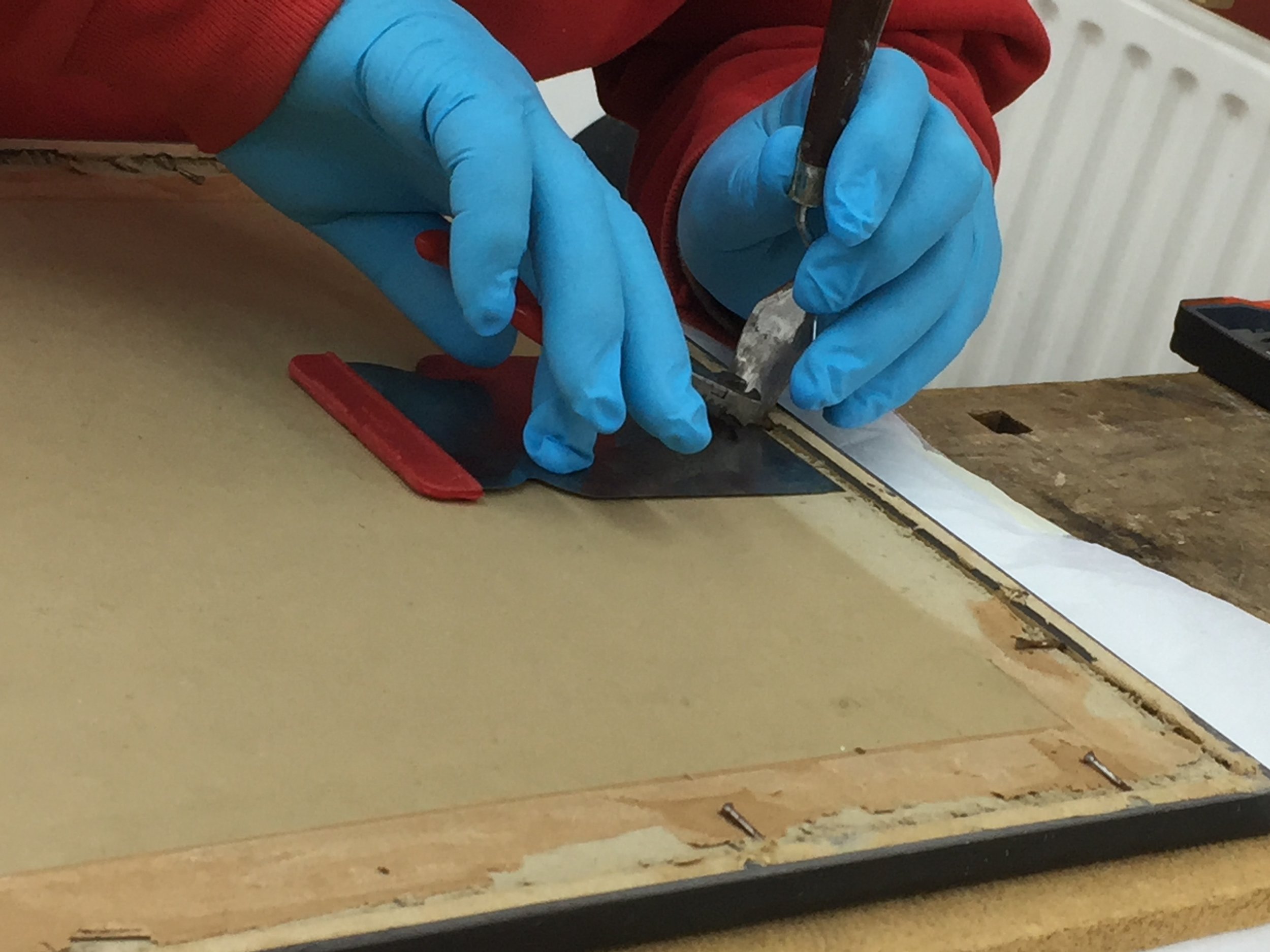  The original backing required removal to reveal the extent of the damage to the glass and to treat the object. This was carried out without damaging the frame so that the glass could later be remounted in its original housing.  