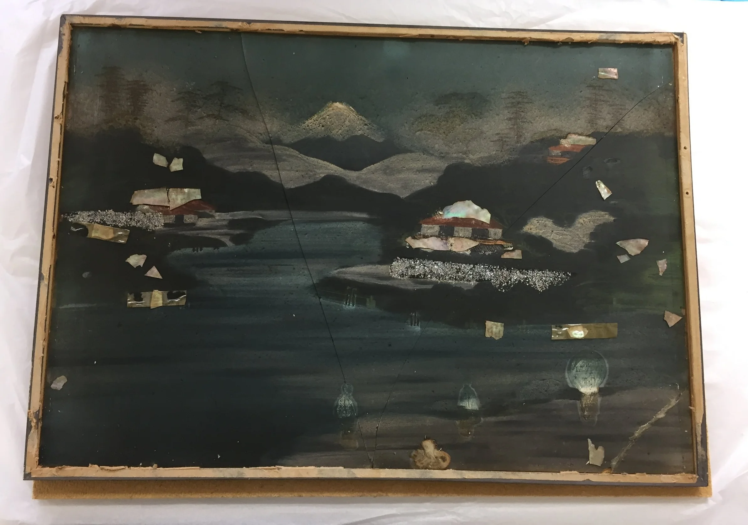  The reverse (painted side) of the glass after the frame was removed. The object had been previously repaired and was very dirty.  