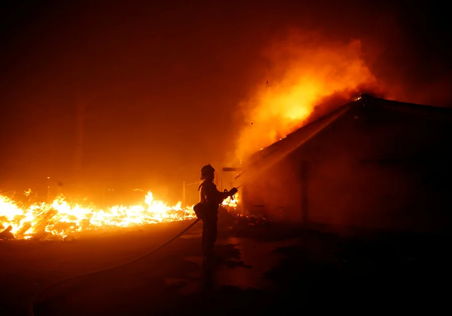 A brave firefighter, battling the Woolsey Fire at Camp Hess Kramer in Malibu, the site of CLF’s holiday events and toy wrap stations.