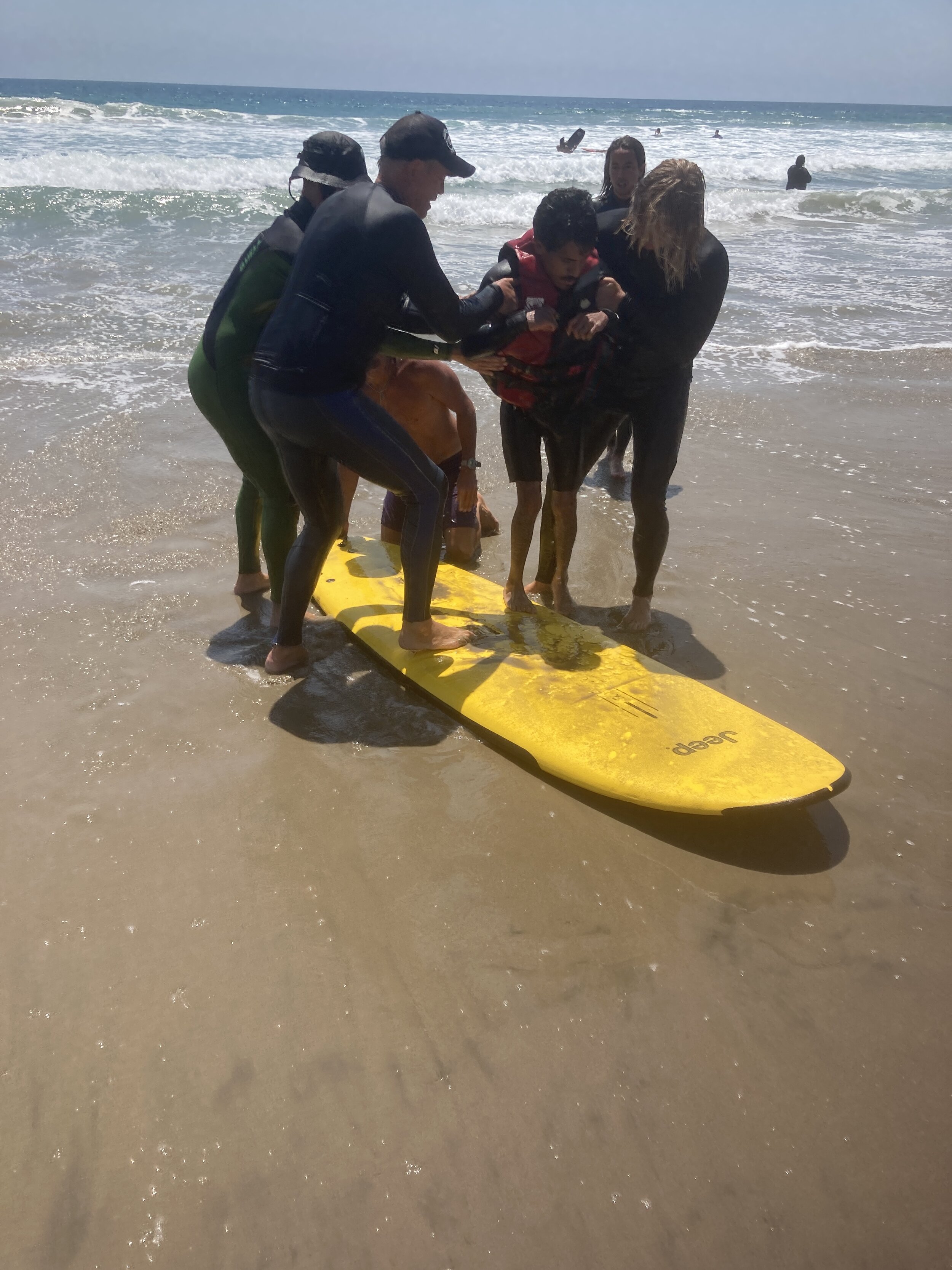 3-Getting Giovanni De Leon on the Surf Board-Camp for All July 17 2021.JPG
