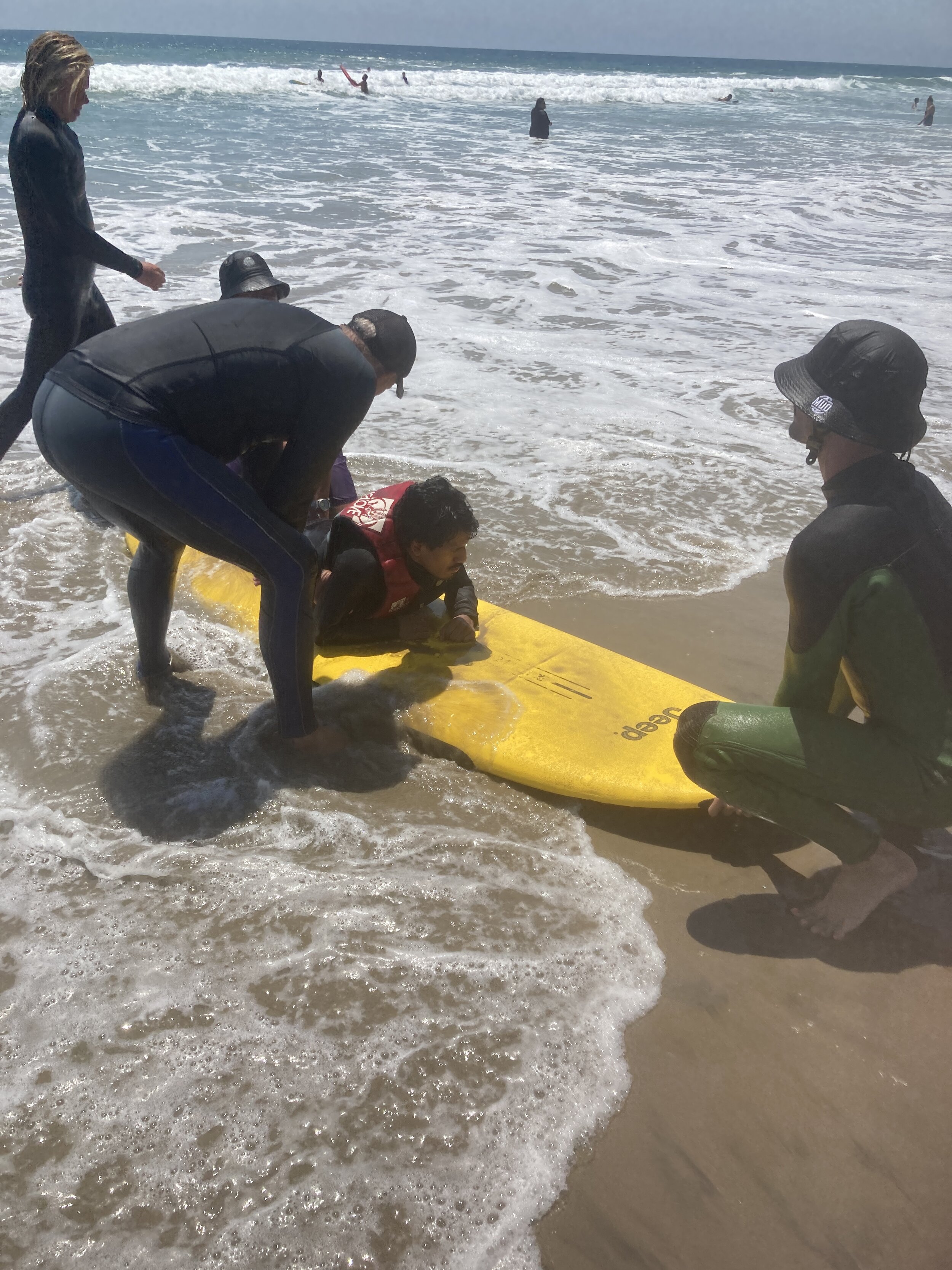 6-Getting Giovanni De Leon on the Surf Board-Camp for All July 17 2021.JPG