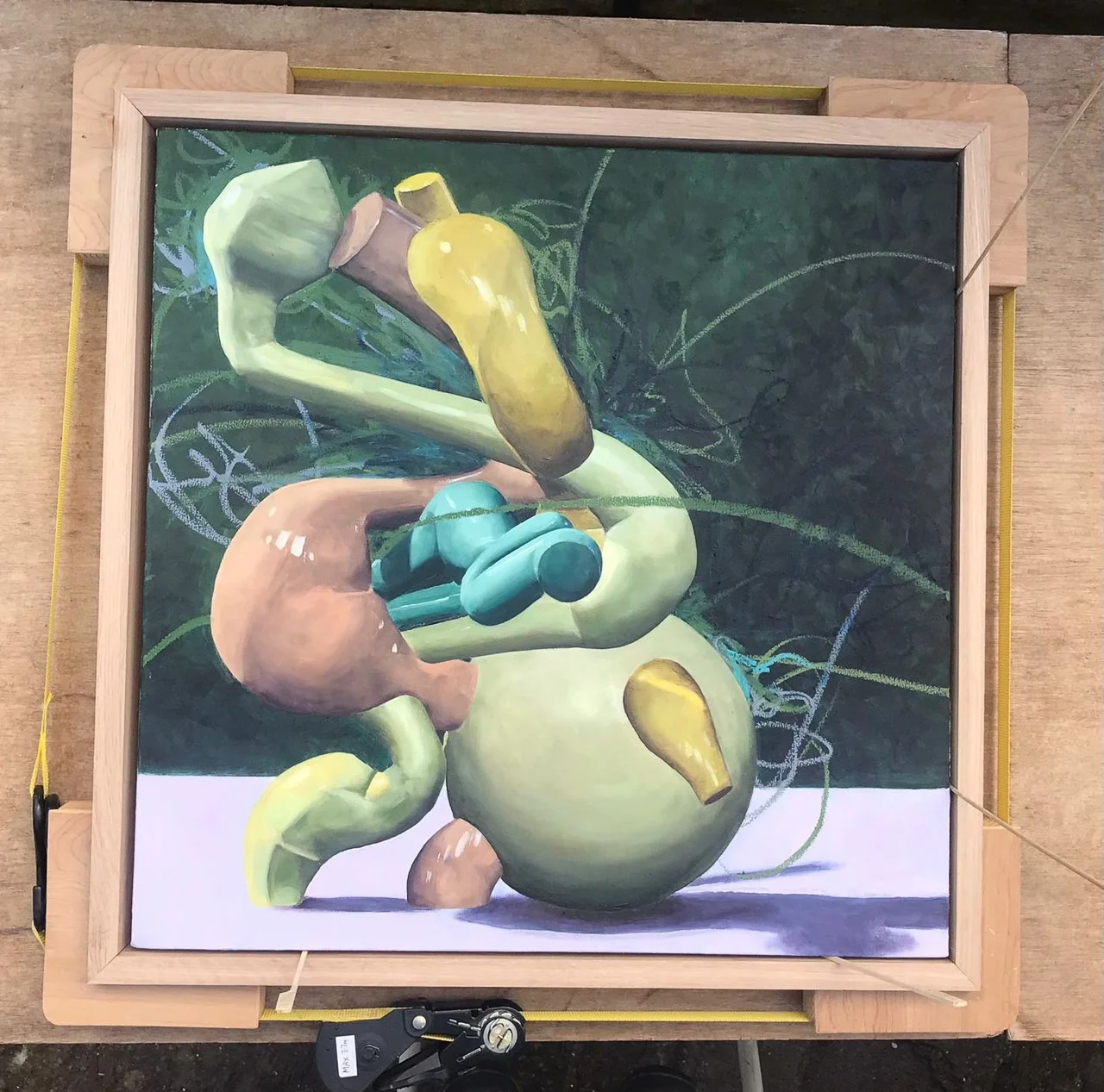 Abstract painting featuring geometric shapes and figures in shades of green, blue, pink, and yellow, set against a dark background with chalk-like lines and curves.