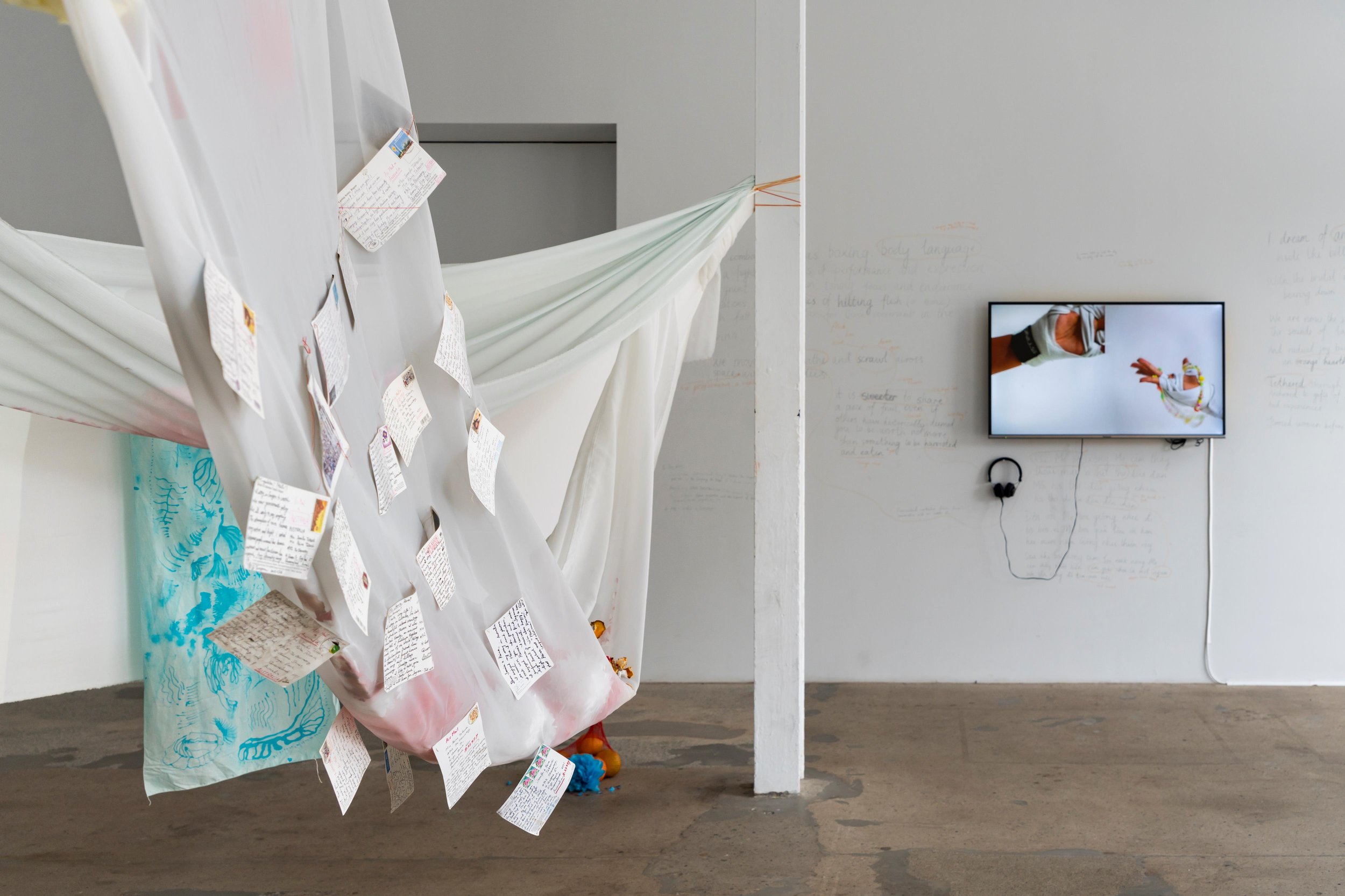   Postcards between the Takeuchis , 2021-2023. Installation, cotton, batik on silk, postcards, kirigami [paper flowers]. Dimensions variable. Photograph by Louis Lim. Courtesy the artist. 