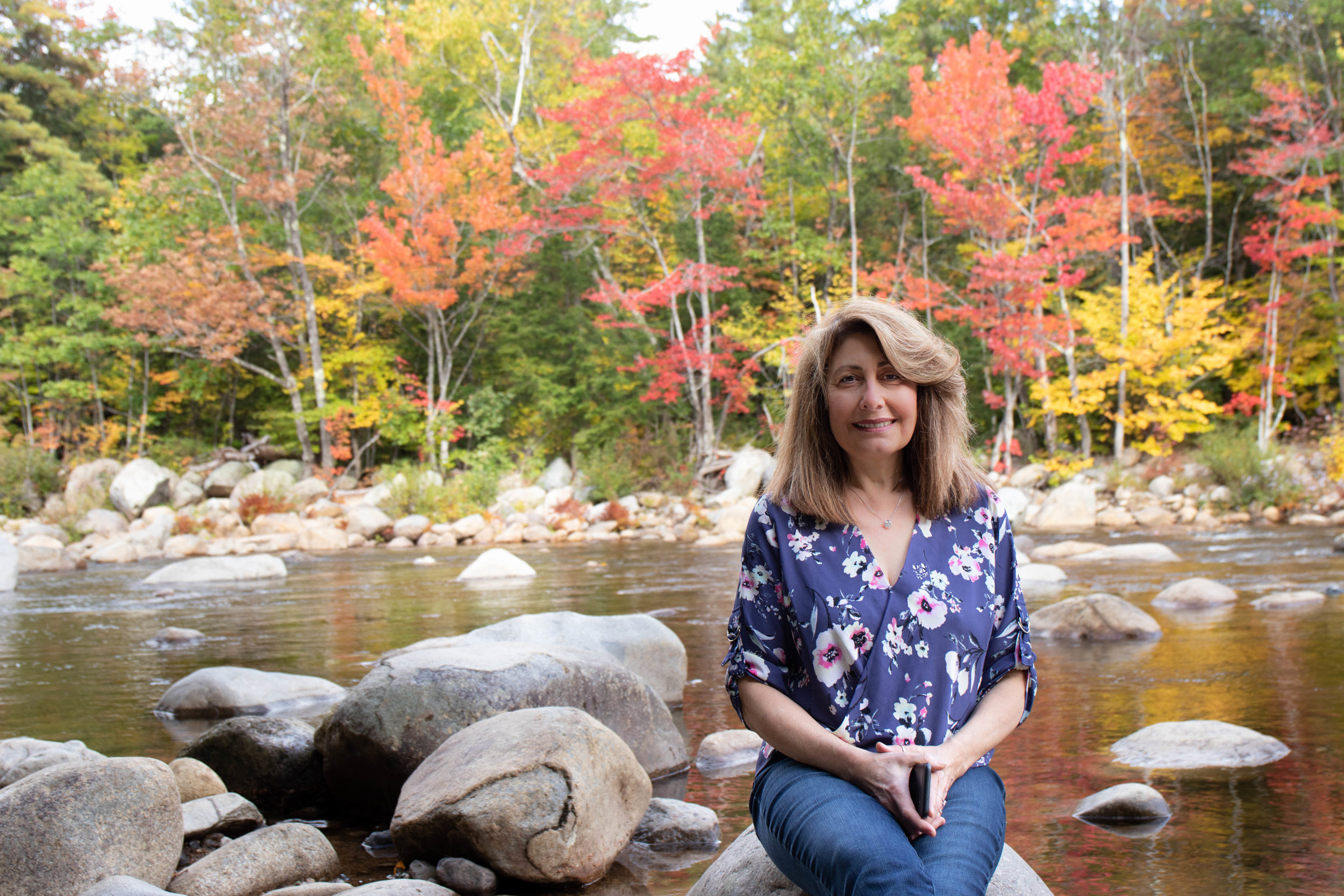 Portrait of woman on the Kancamagus Highway in North Conway, New Hampshire during fall by Vision Balm in Charleston, SC.