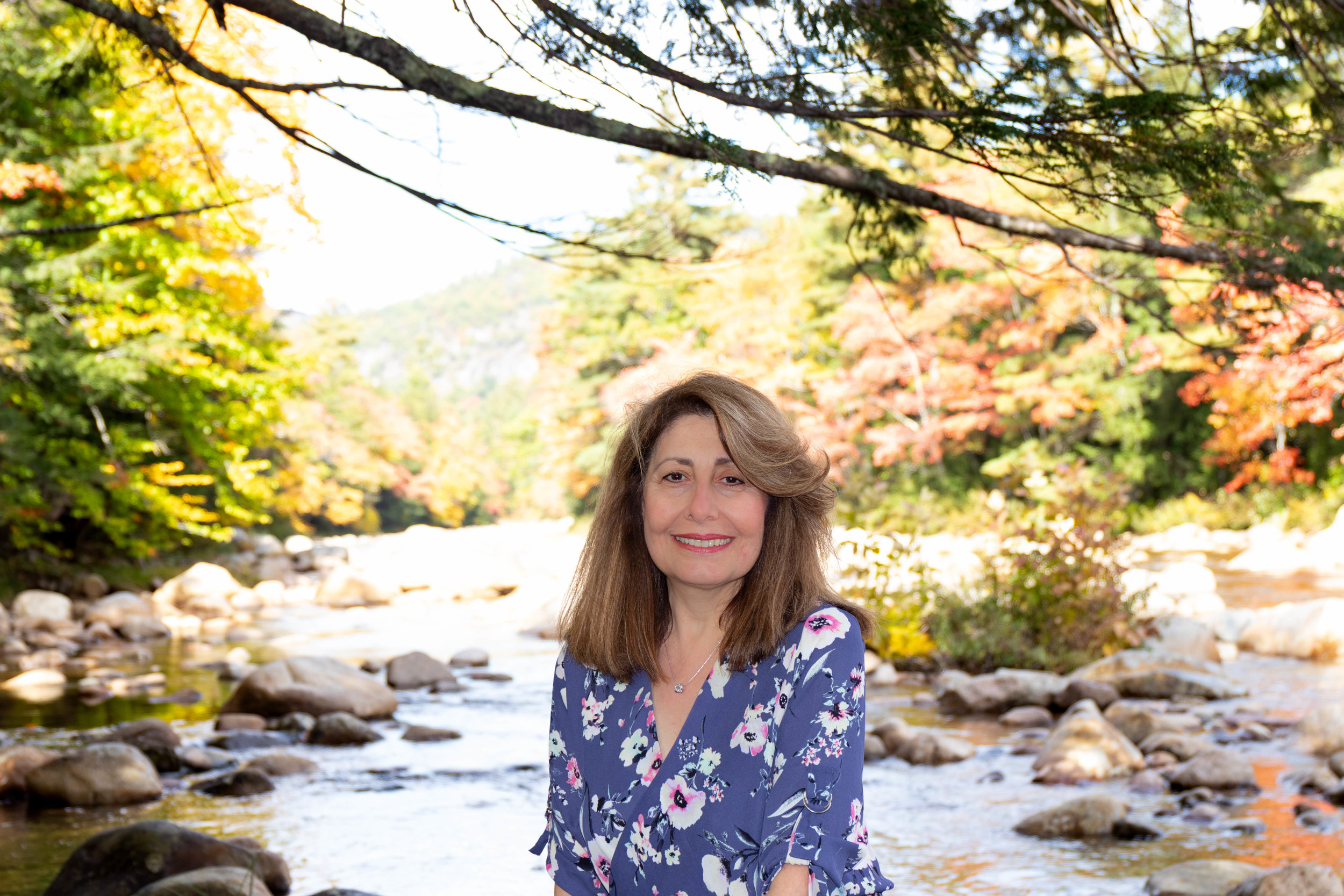 Portrait of woman on the Kancamagus Highway in North Conway, New Hampshire during fall by Vision Balm in Charleston, SC.