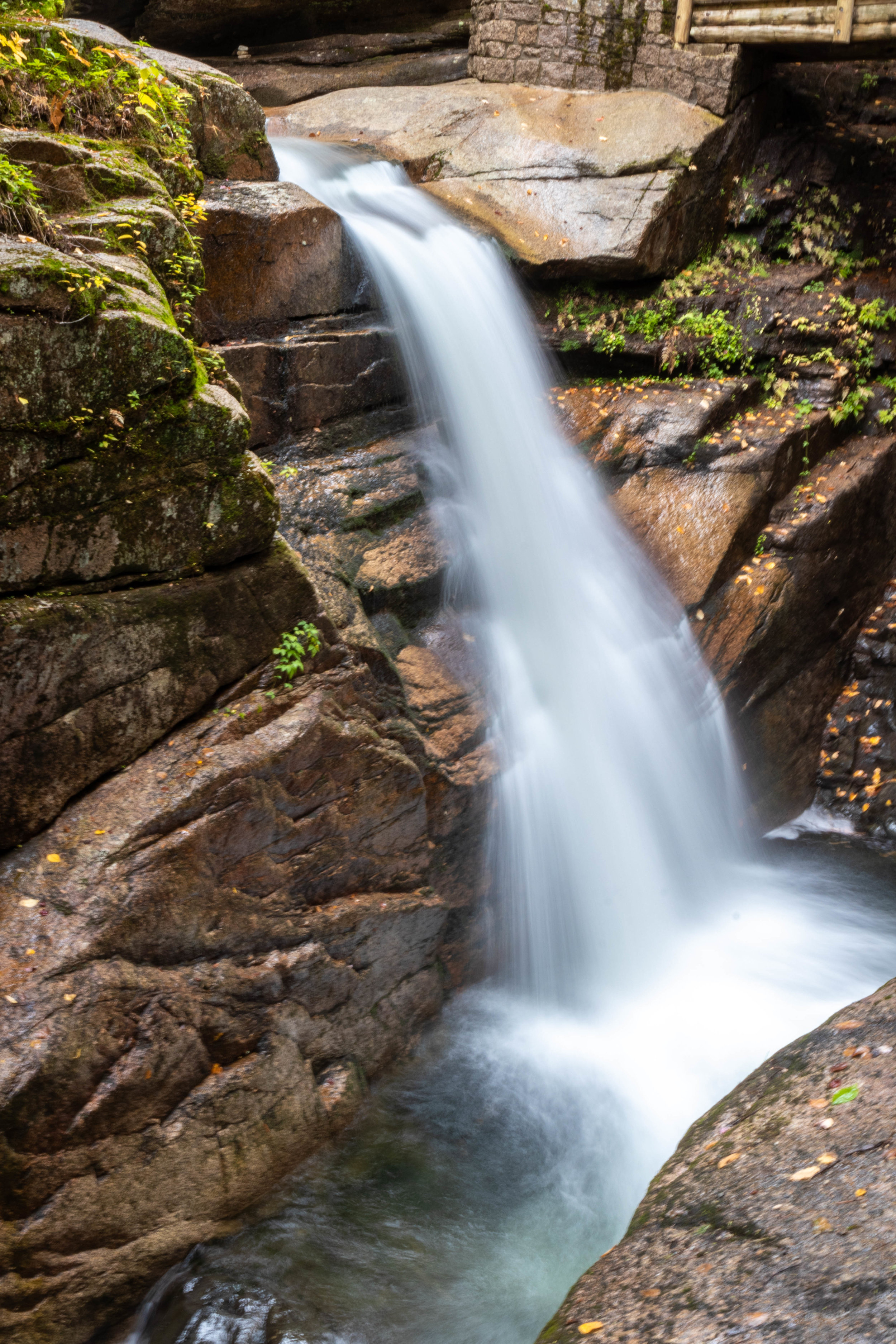 Landscape photo of a waterfall along the Kancamagus Highway in North Conway, New Hampshire by Vision Balm in Charleston, SC.