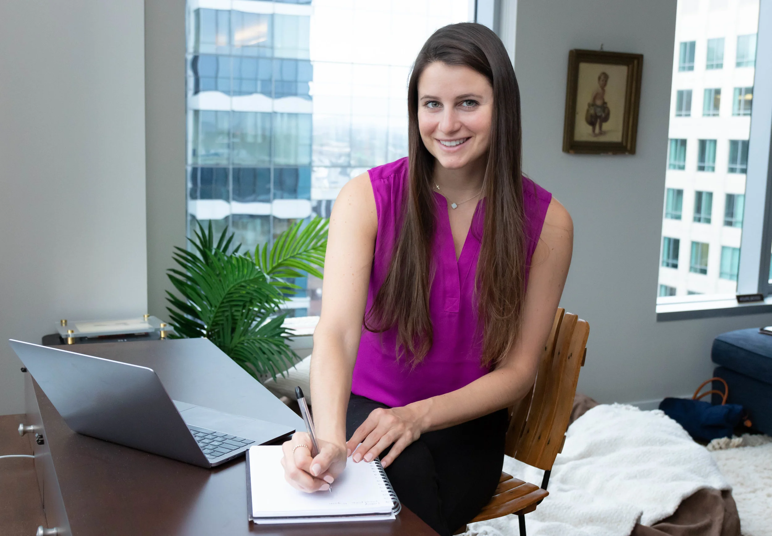 Lifestyle portrait photography of Erin Kenney from Nutrition Rewired registered dieititan working on her laptop and notepad photographed by Vision Balm in Charleston, SC.