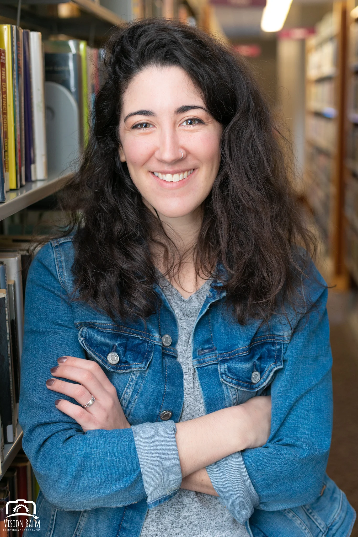 Portrait of Lauren Alicandro female multimedia producer and writer at the public library photographed by Vision Balm in Charleston, SC.