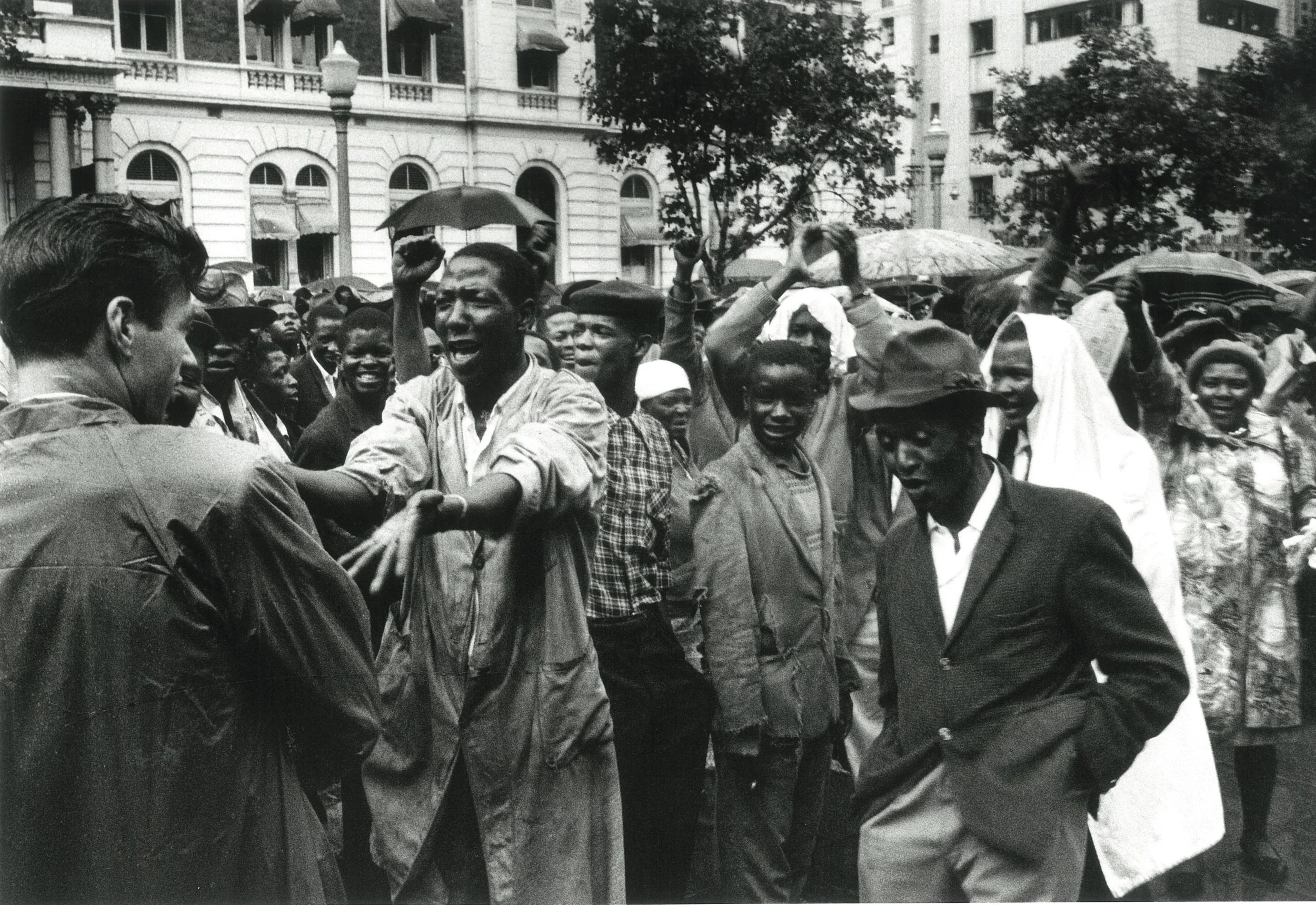 1960 – Africans at the Congress of Democrats rally in the rain, outside Johannesburg Town Hall Courtesy of the Estate of John Goldblatt