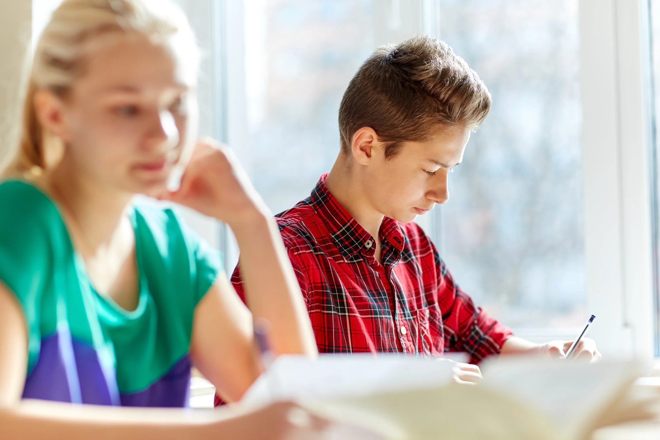 group-of-students-with-books-writing-school-test-PQ99RAX.jpg