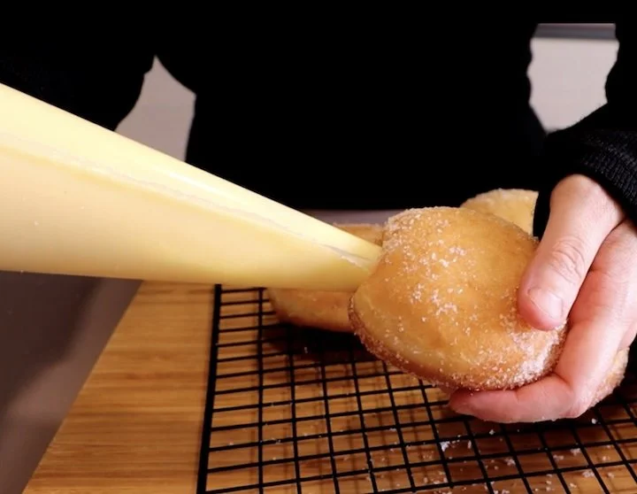 Filling a donut with custard